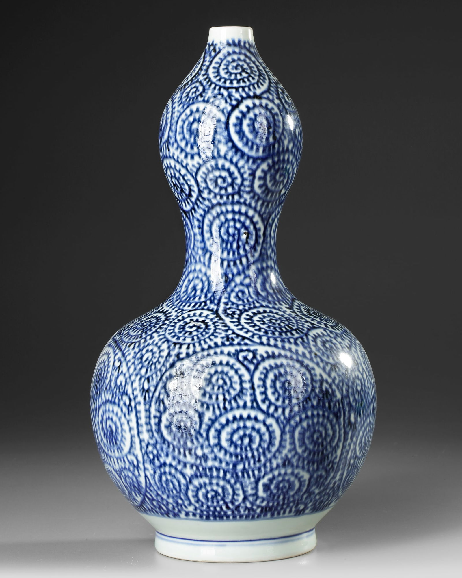 A JAPANESE BLUE AND WHITE  DOUBLE- GOURD SAKE VASE, WITH OCTOPUS AND KARAKUSA, LATE EDO PERIOD, 18TH (1 of 4)
