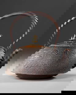 A JAPANESE CAST IRON TETSUBIN – CRANE AND WAVES DESIGN WITH BRONZE LID,EDO PERIOD (1615–1868): This authentic Japanese Tetsubin is a traditional cast iron teakettle featuring finely embossed motifs of a crane in flight and stylized ocean waves, symbols of longevity and strength in Japanese cult
