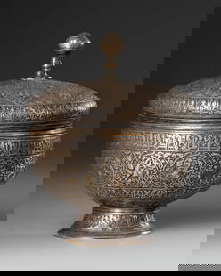 A PERSIAN SILVER INLAID LIDDED BOWL, KHURASAN STYLE, 20TH CENTURY: A lidded bowl of high tin bronze, engraved and inlaid with silver. The bowl and the lid decorated with a band containing twelve roundels enclosing signs of the zodiac, it displays a complex astrologic