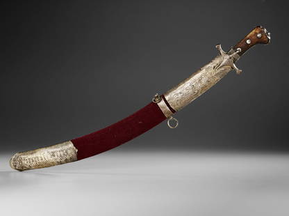 AN OTTOMAN STEEL SWORD (SHAMSHIR) AND SCABBARD, 18TH CENTURY: An Ottoman sword with fine watered steel blade gently curved, the hilt is a straight silver engraved crossguard with double langets and engraved silver strap around the tang. The wooden grips are rive