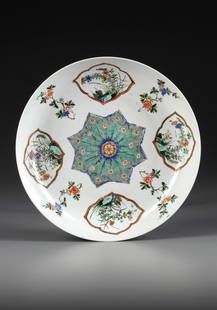A CHINESE FAMILLE VERTE 'FLORAL' DISH, KANGXI PERIOD (1662-1722): The dish is decorated to the centre with a star-shaped floral panel surrounded by four quatrefoil cartouches enclosing various flowers, all separated by prunus and peony sprays. The exterior is decora