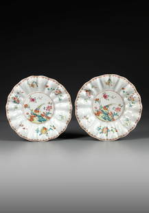 A PAIR OF CHINESE FAMILLE ROSE 'PHEASANT AND PEONY' SCALLOPED-RIM DISHES, QIANLONG PERIOD: Each dish is decorated with a pair of pheasants amongst blossoming peonies in a fenced garden, the scalloped rim is decorated with a multitude of flower sprays, all surrounded by a gilt spearhead bord