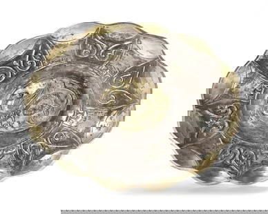 GREEK SILVER BOWL WITH GILT DECORATION – 5TH CENTURY: An ornate silver bowl featuring a central winged serpent in gilt relief. Surrounded by radiating panels with stylized scrollwork and Greek inscriptions, it exemplifies high craftsmanship and mythologi