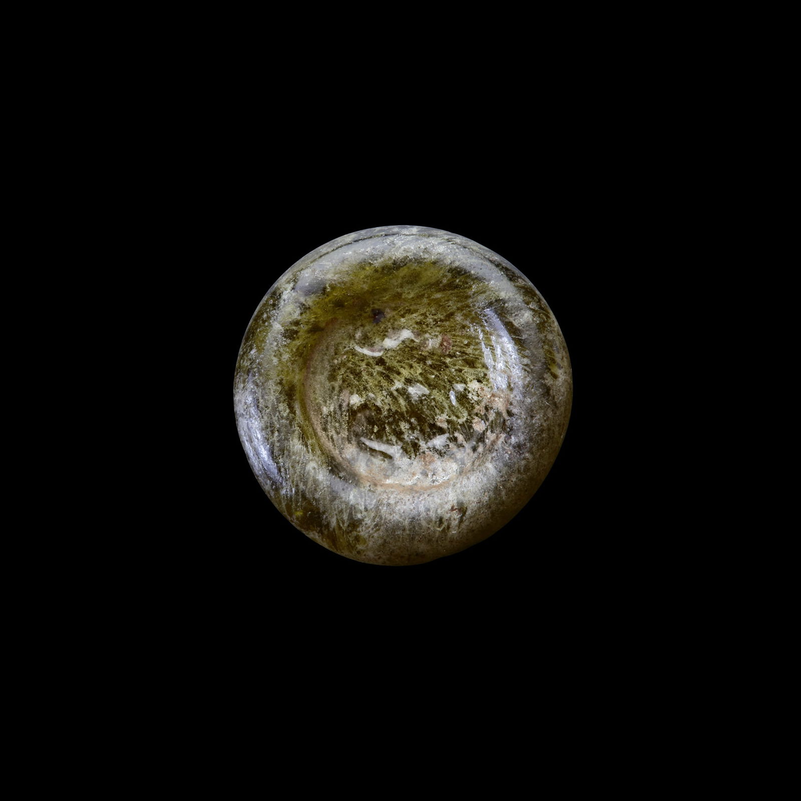 AN EARLY ISLAMIC GLASS WEIGHT OF HALF DIRHAM, 10TH-11TH CENTURY: Glass weight, moulded and stamped, transparent light-green in colour, citing in the centre with 2 lines of undeciphered Arabic text. 1,602 g., 15 mm. coin weight: half dirham.
