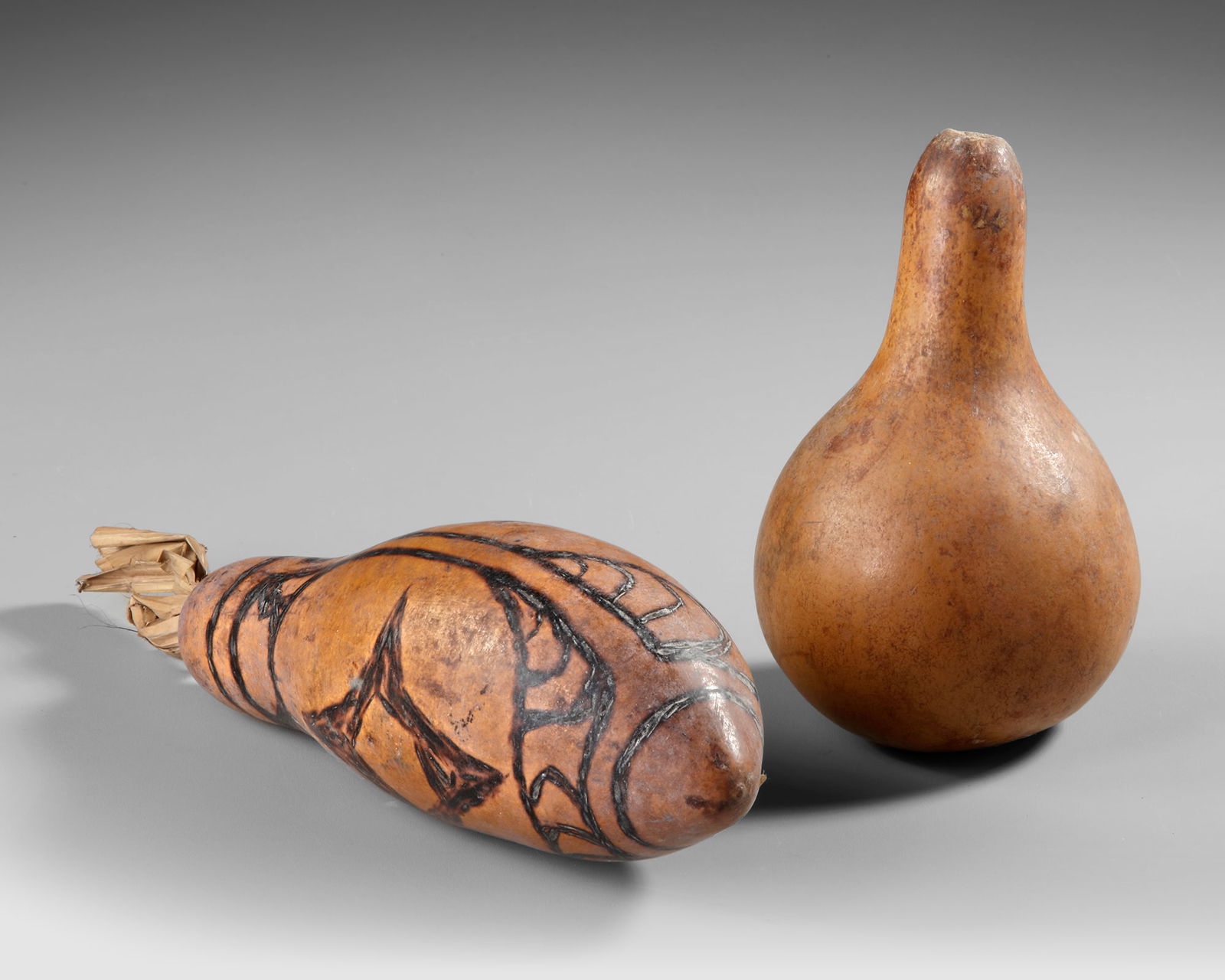 Two Sentani gourd lime containers. Collected by Jac Hoogerbrugge in the 1950’s: 1. 23 cm. 2. 13 cm.