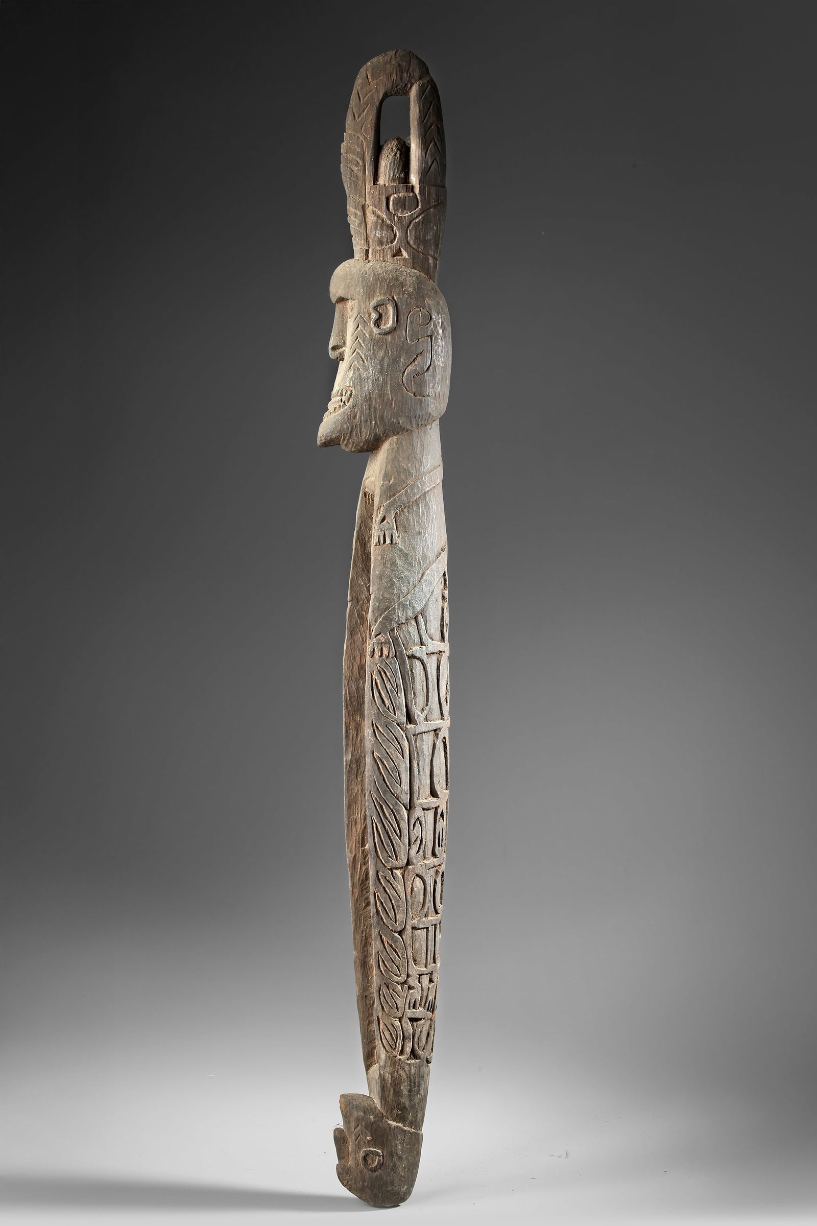 Asmat sago bowl in the form of a neckrest. Collected by Jac Hoogerbruge. See his drawing and: 100 by 12 by 10 cm.