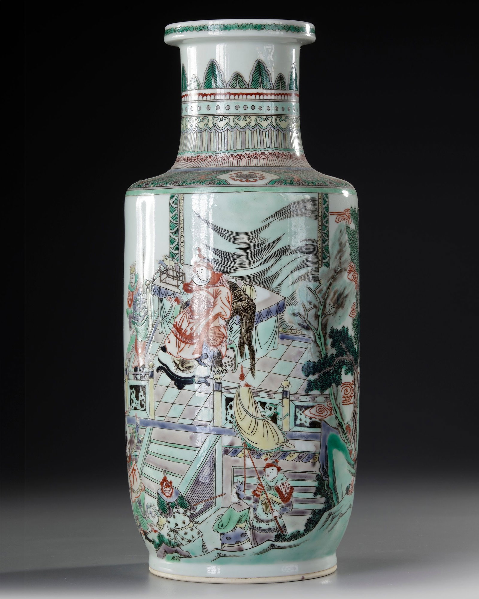 A CHINESE FAMILLE-VERTE ROULEAU VASE, QING DYNASTY (1644-1911): A Chinese porcelain vase decorated in famille verte enamels with interior scenes of court life, the shoulder with a diaper band containing cartouches enclosing flower heads, the neck with a band of se