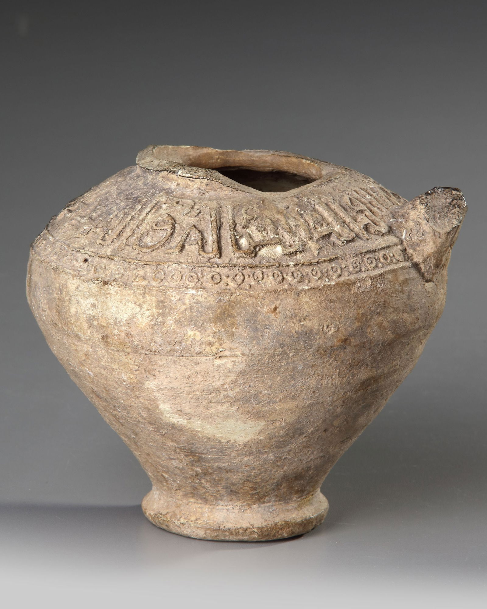 A SELJUK UNGLAZED MOULDED POTTERY VESSEL, PERSIA, 12TH-13TH CENTURY (1 of 4)
