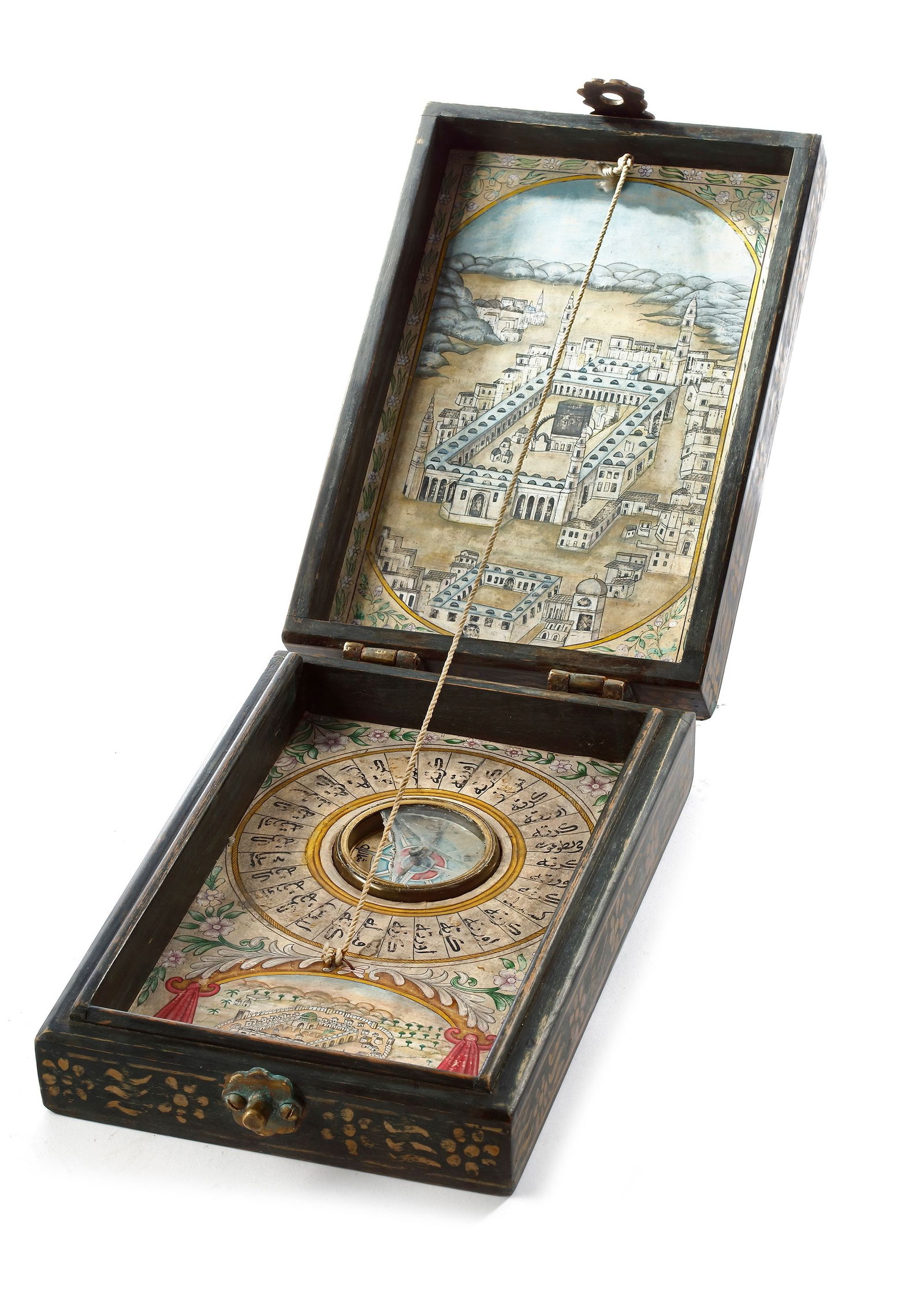 AN OTTOMAN COMPASS AND QIBLA INDICATOR, 19TH CENTURY: A case, the frame painted in gold, decorated with a crescent moon and star in the center, opening in two parts. The inside of the cover painted with a central medallion representing aerial view of al-