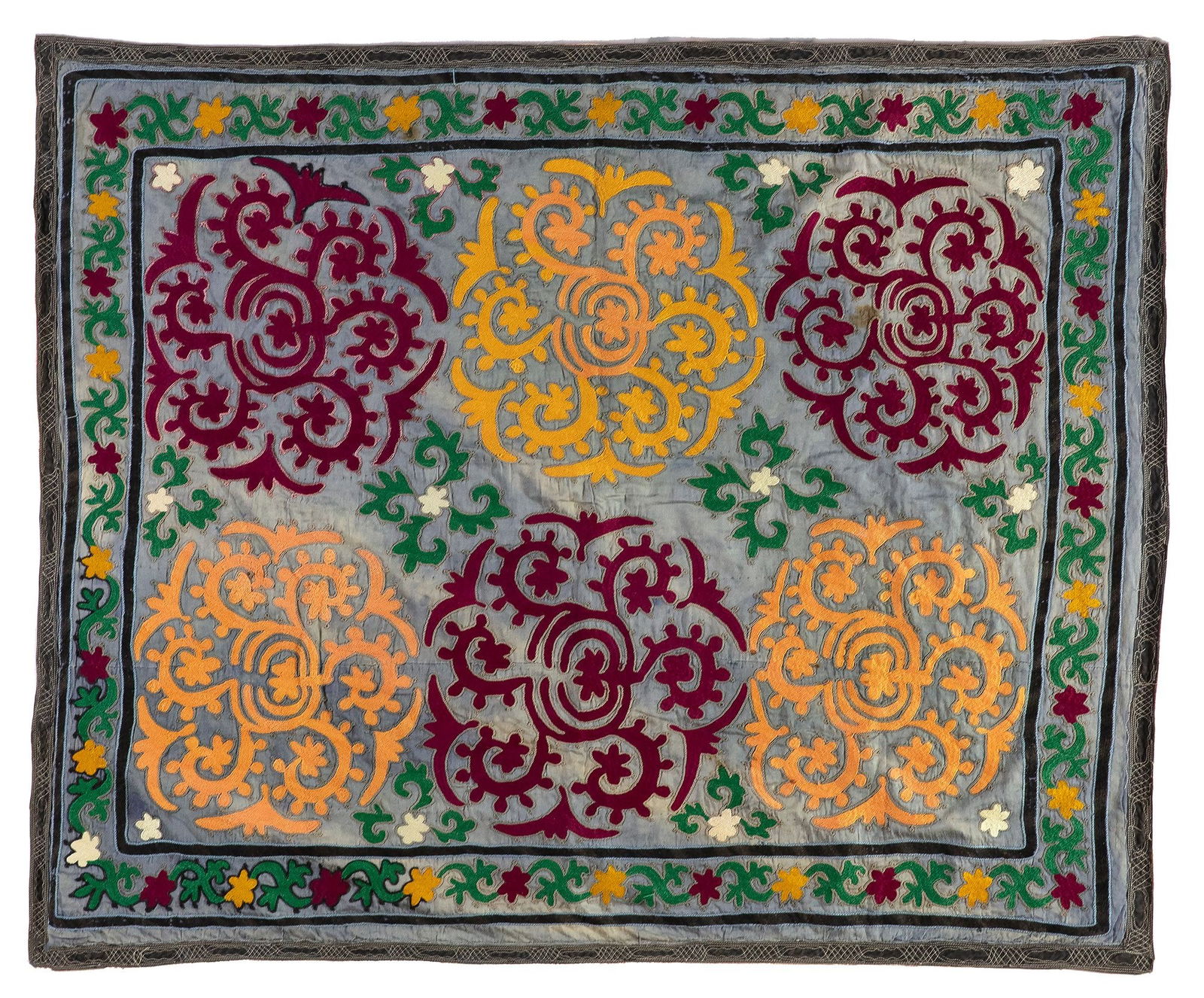 AN UZBEKI EMBROIDERY HANGING PANEL, CENTRAL ASIA, 19TH CENTURY: The square rumal twill-tapestry woven in coloured wools and joined inserts in white, yellow, deep red and green on a light blue ground, the central panel decorated with floral stylised roundels, the e