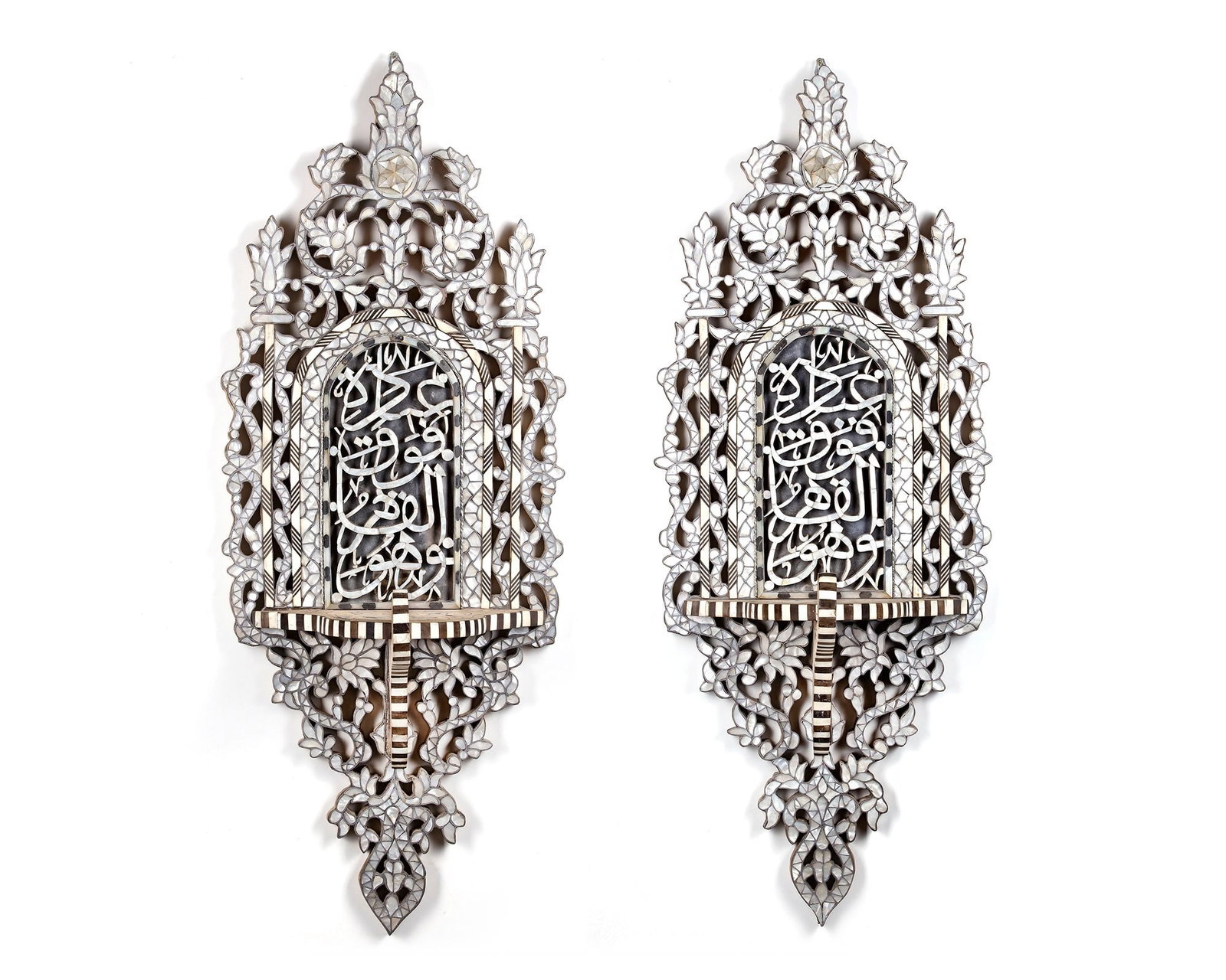 A PAIR OF OTTOMAN MOTHER OF PEARL INLAID WOODED TURBAN STANDS (KAVUKLUK), TURKEY, EARLY 20TH CENTURY: Of typical shape, the turban holder shelf slanting forward at 2/3 of the full height. The decoration consisting of mother-of-pearl, bone and wood marquetry work in a typical Ottoman-revival style feat