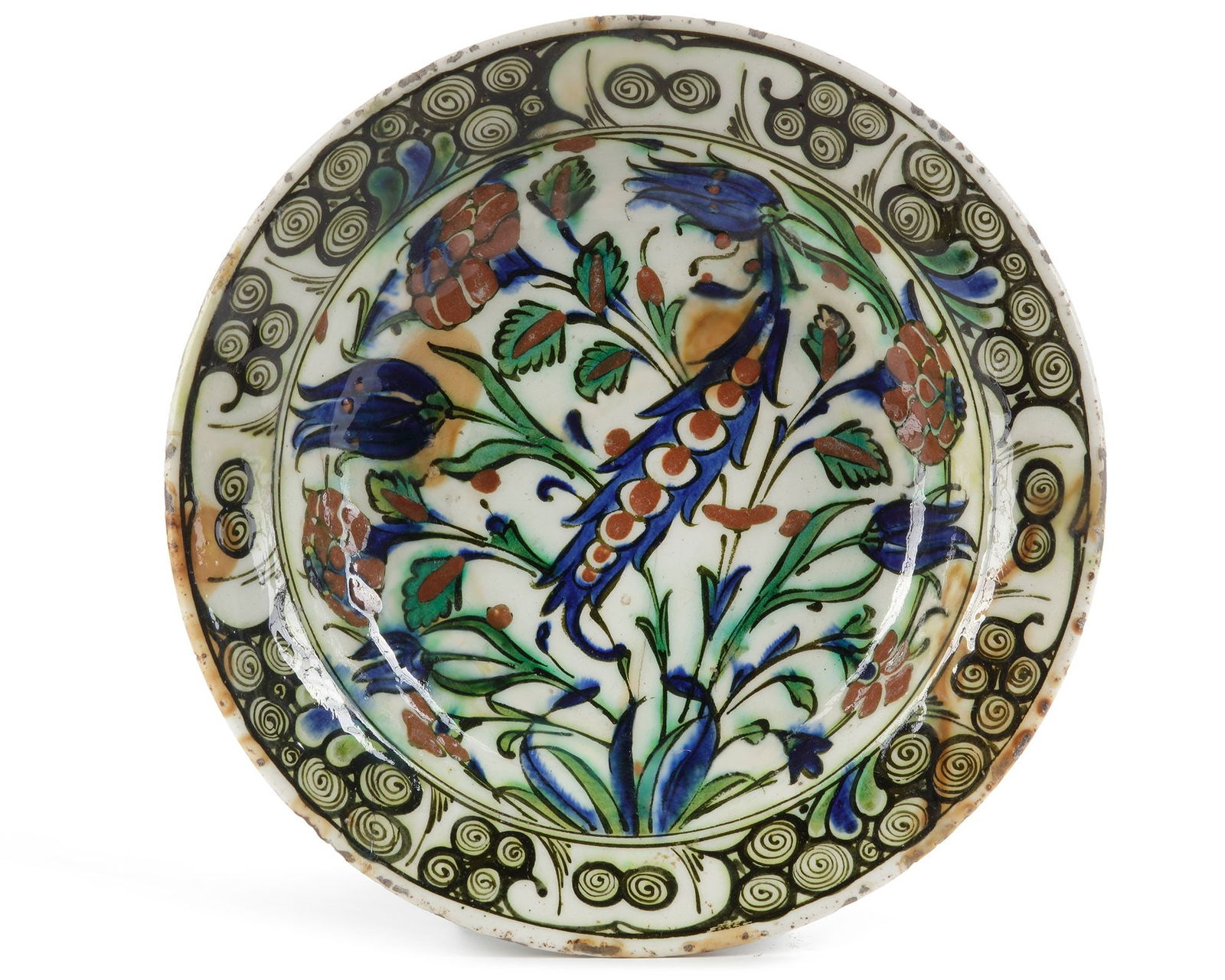 AN IZNIK POTTERY DISH WITH QUATRE FLEURS DECORATION, OTTOMAN TURKEY, 16TH CENTURY: 25.5 cm. diam.
