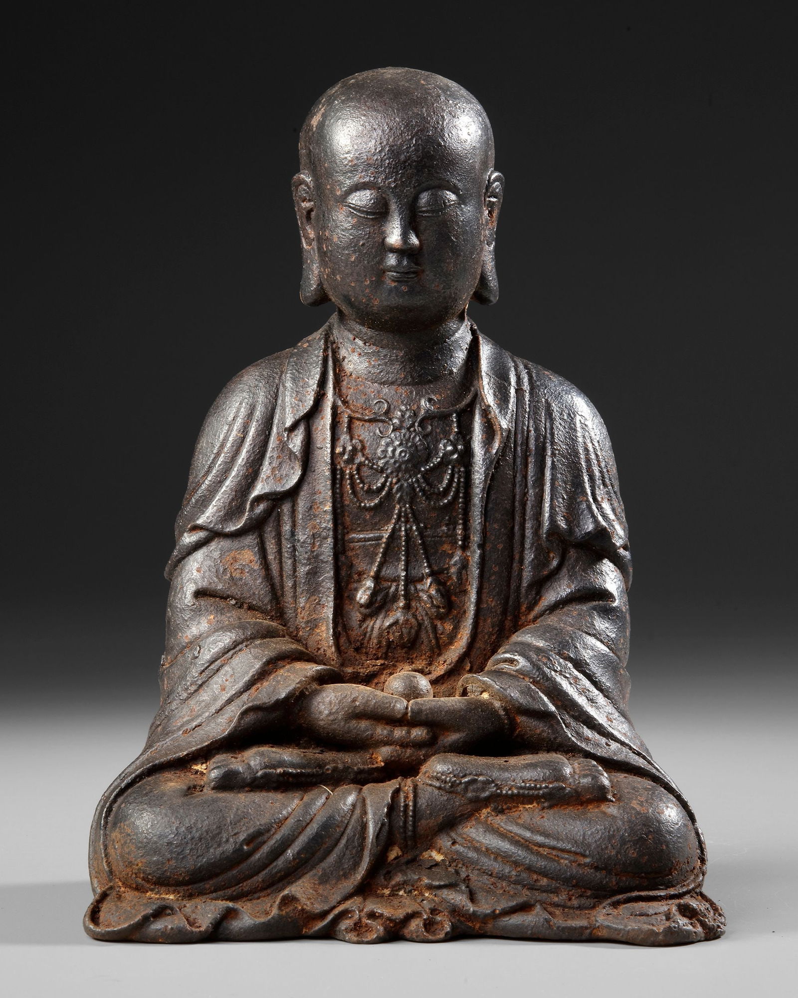 CHINESE BRONZE FIGURE, 19TH CENTURY: A finely cast Chinese bronze figure depicting a serene seated figure in meditative posture, hands resting in dhyana mudra.H. 26 cm.