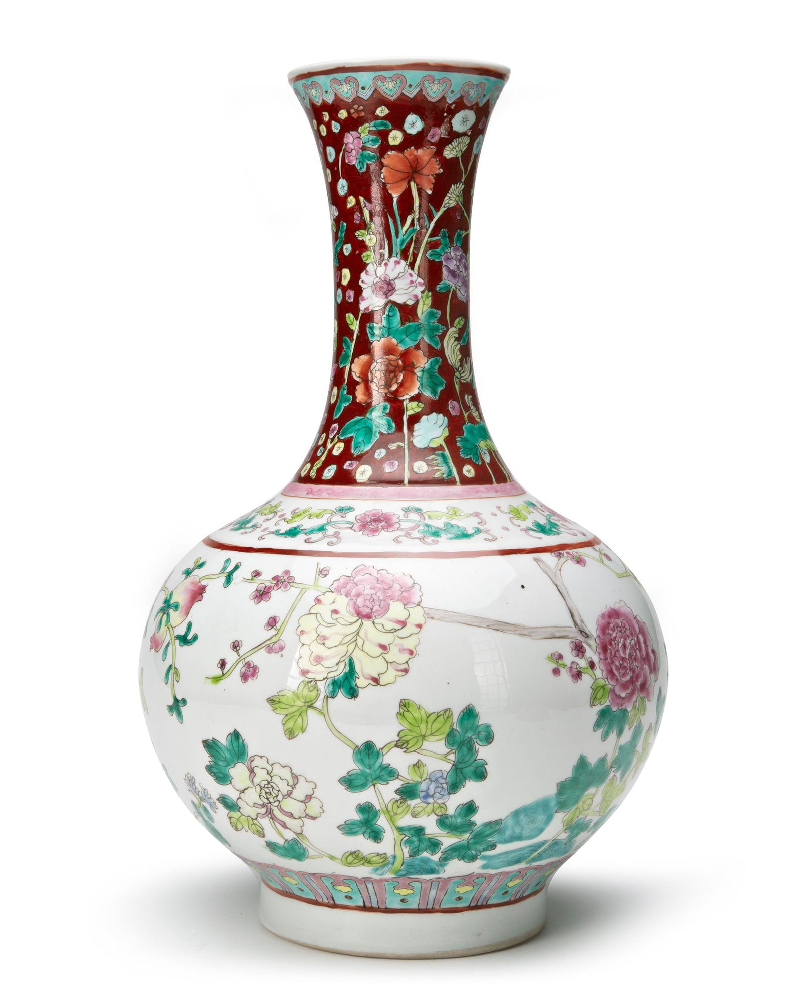 A CHINESE FAMILLE ROSE BOTTLE VASE, 20TH CENTURY: A Chinese porcelain bottle vase, decorated in famille rose enamels with pomegranate and peony blossoming branches, classic flower scrolls around the shoulder, the neck with lotus, lilies, peony and ch