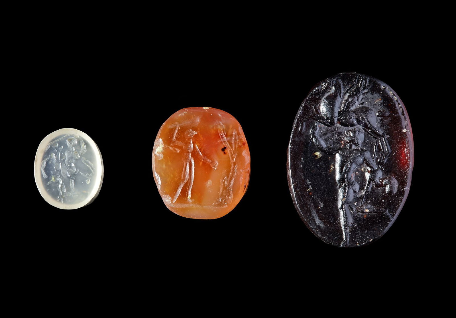 TWO ROMAN INTAGLIOS AND A LATER CAST GLASS IMPRESSION, 2ND CENTURY AD AND 19TH CENTURY AD (1 of 4)