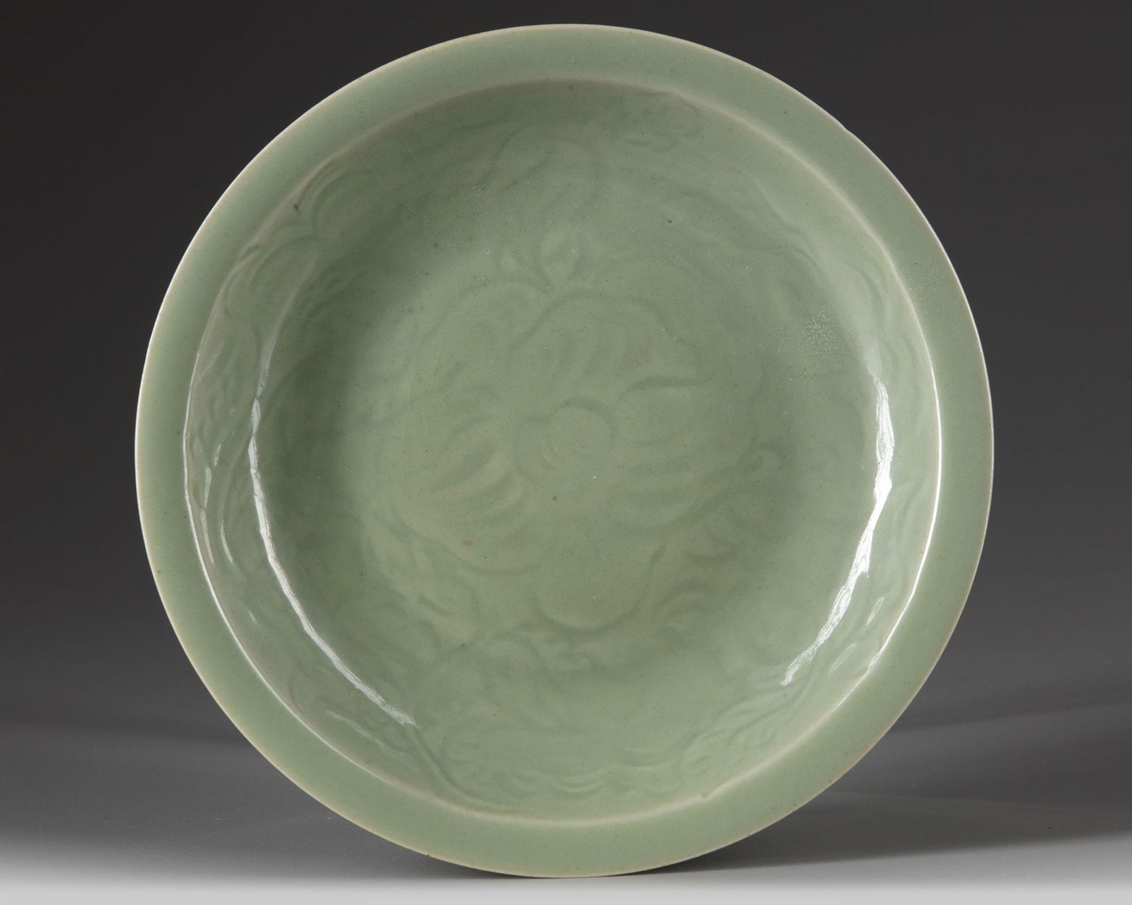 A CHINESE CELADON GLAZED DISH, POSSIBLY MING DYNASTY (1 of 2)