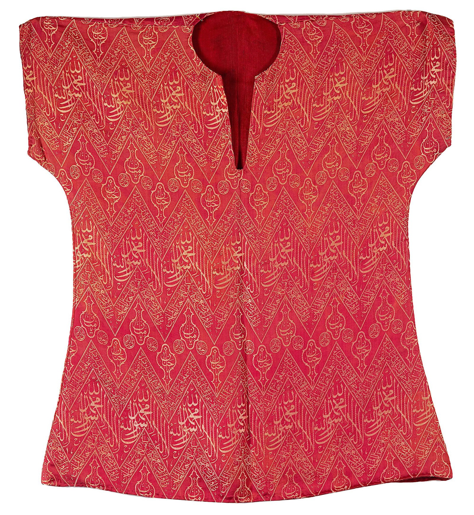 AN OTTOMAN LAMPAS-WEAVE TUNIC MADE FROM A CENOTAPH COVER, TURKEY, LATE 19TH CENTURY: An Ottoman Talismanic shirt made from sacred kiswa for the inner wall of the Kabaa with an inscribed weave in cream-colored silk over a dark red ground. The crests of the chevrons are embellished with
