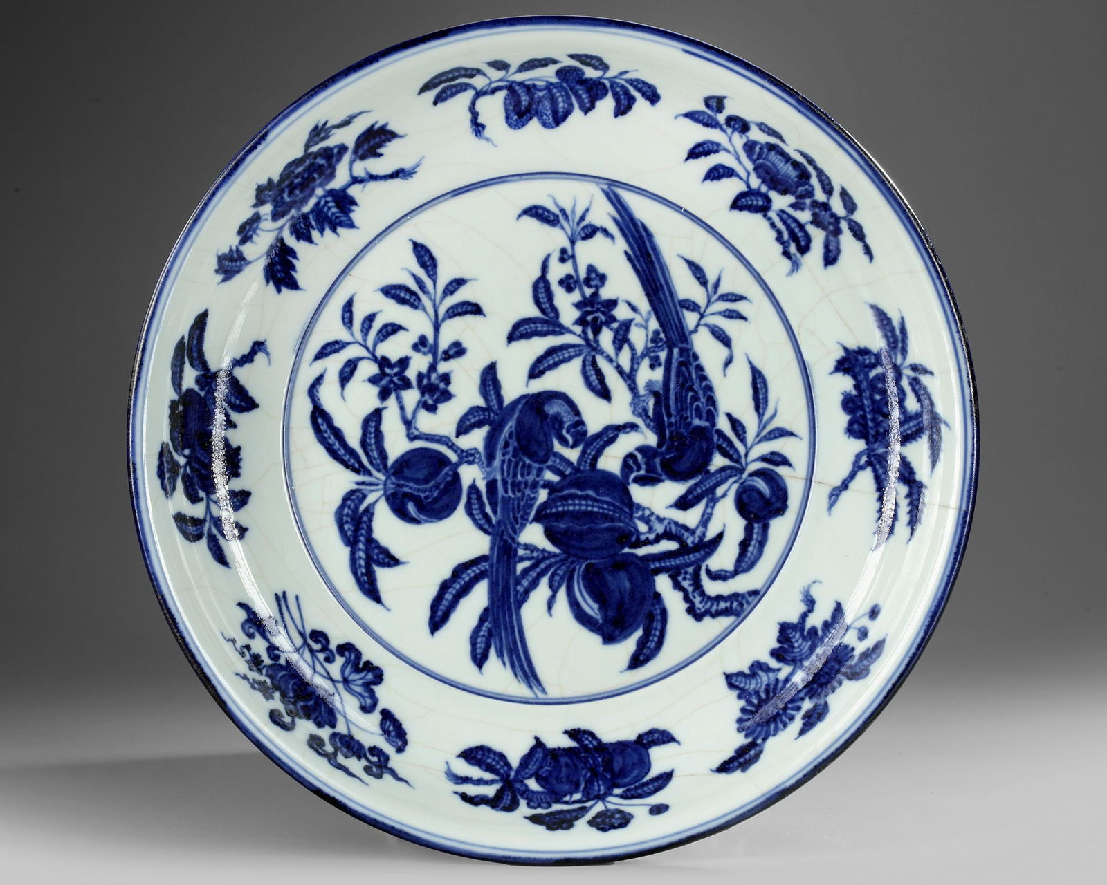 A CHINESE BLUE AND WHITE 'BIRDS' CHARGER, QING DYNASTY (1644â€“1911) (1 of 2)