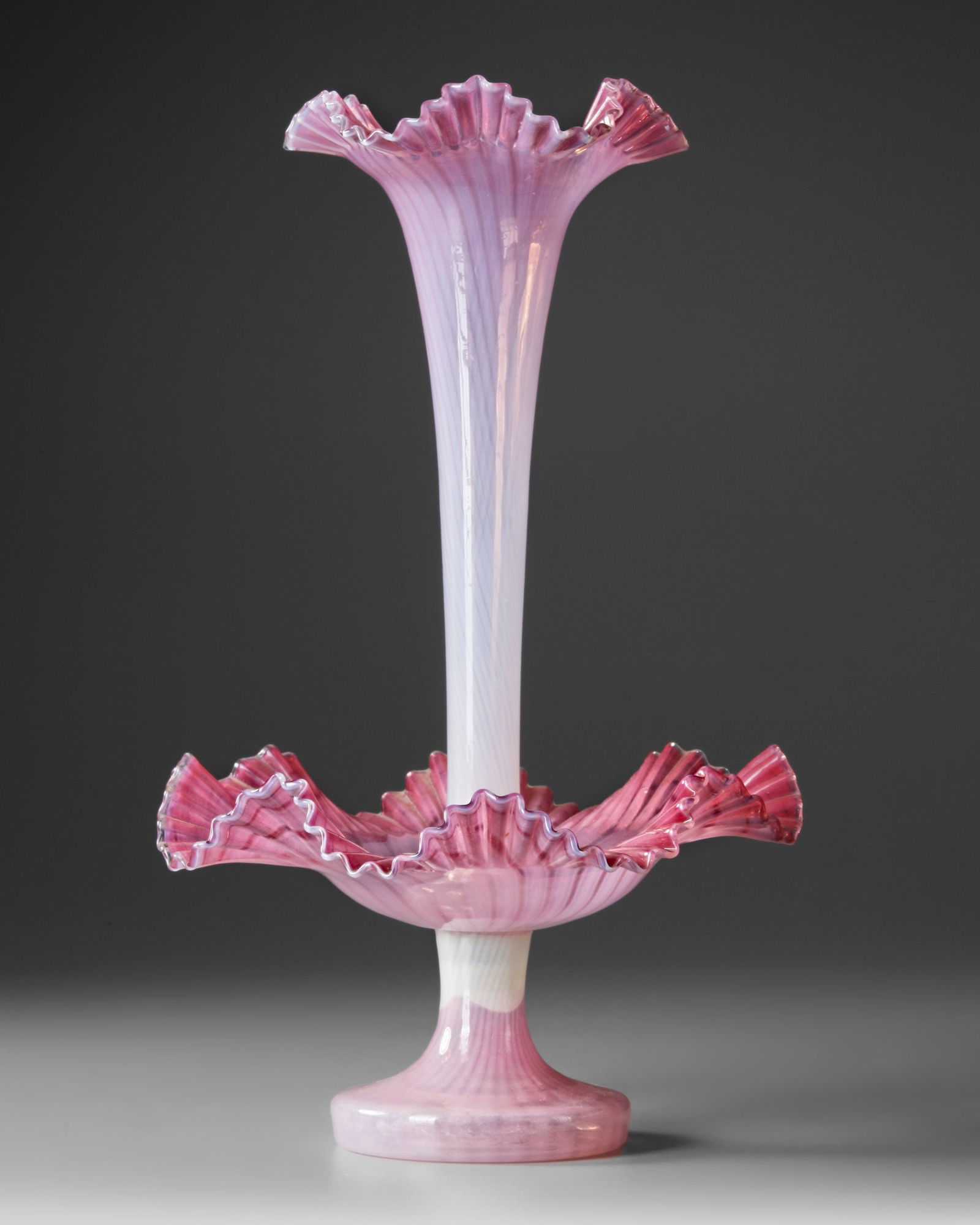 A VICTORIAN OPALINE GLASS EPERGNE CENTERPIECE, 19TH CENTURY: A stunning 19th-century Victorian opaline glass epergne centerpiece featuring a delicate fluted trumpet vase supported by an intricately ruffled lower dish. The glass showcases a soft pink gradient wi