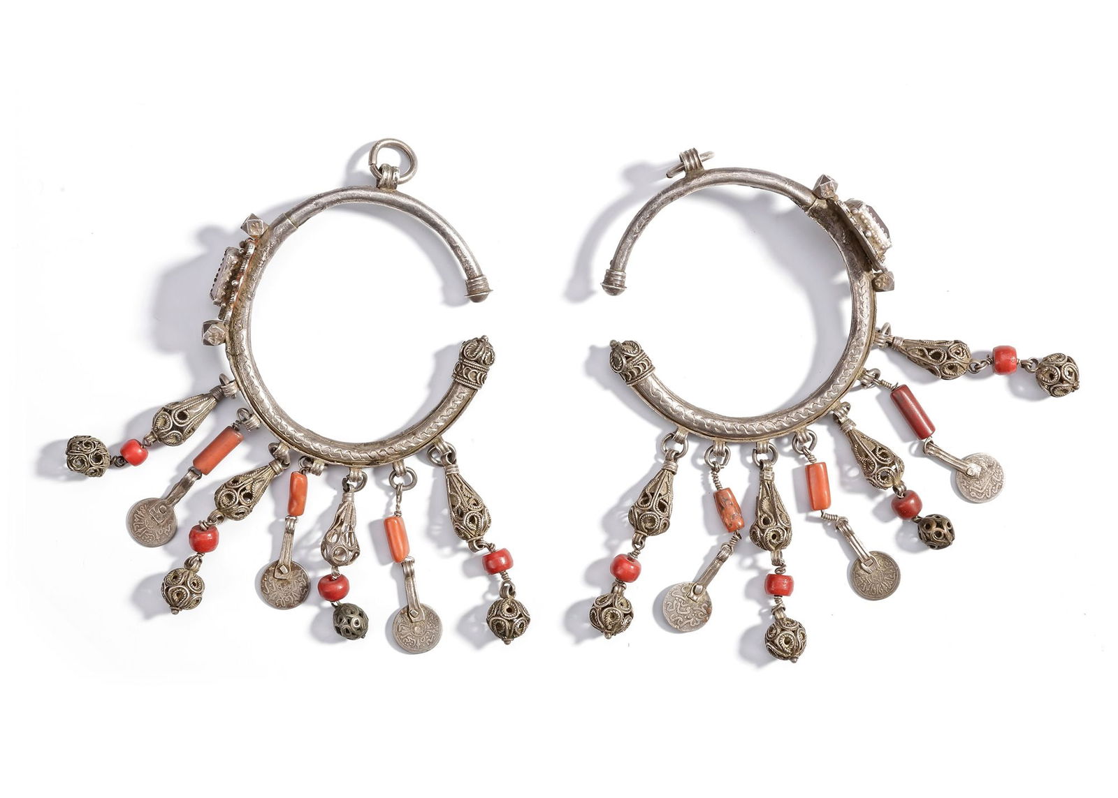 A PAIR OF SILVER EARRINGS, MOROCCO, 19TH CENTURY: Ornate silver earrings with coral beads, filigree pendants, and coin charms. 8 cm. 160 gr. THE DR. SAAD AL-JADIR COLLECTION
