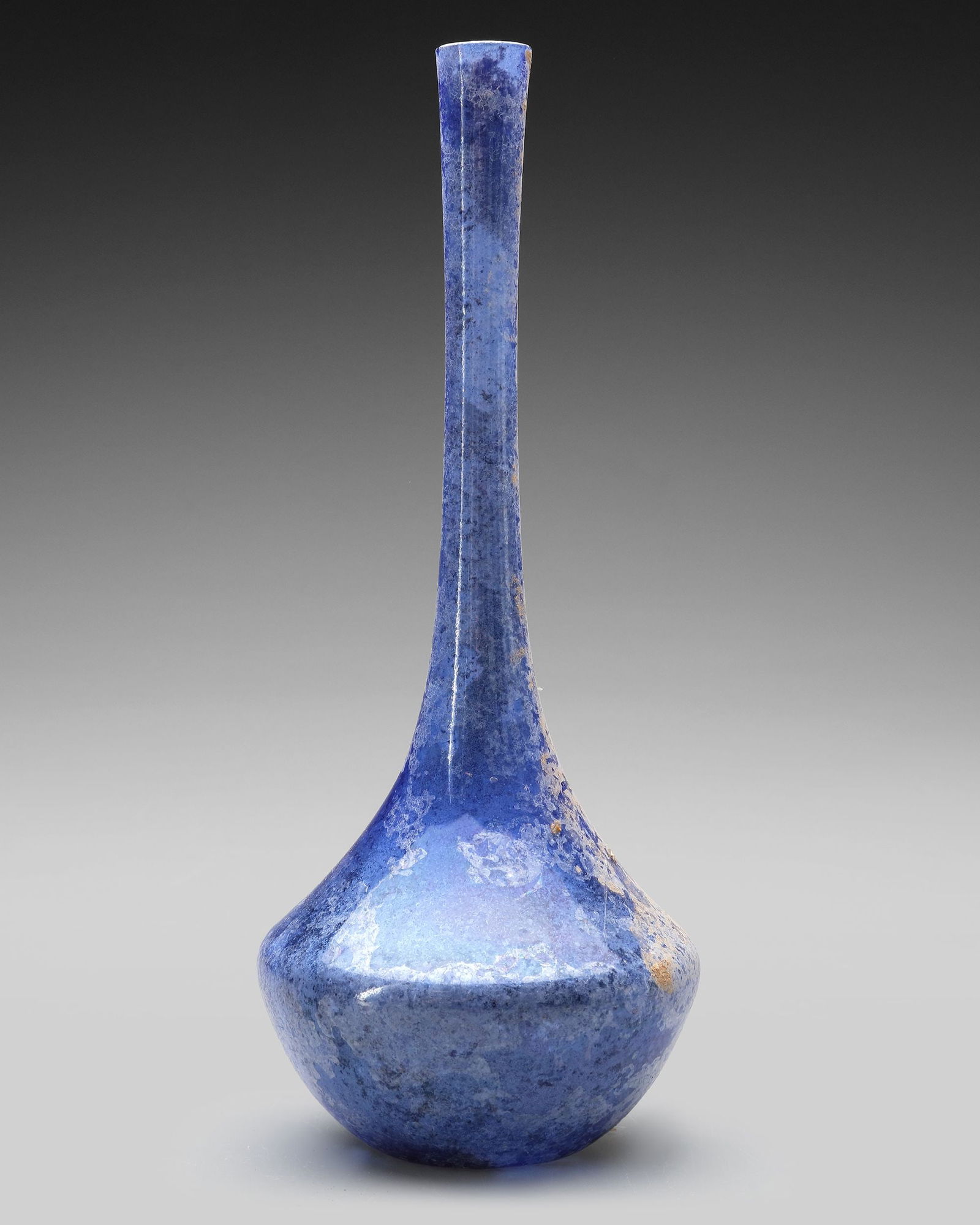 A TALL-NECKED BLUE GLASS BOTTLE PERSIA OR SYRIA, 11THâ€“12TH CENTURY (1 of 5)