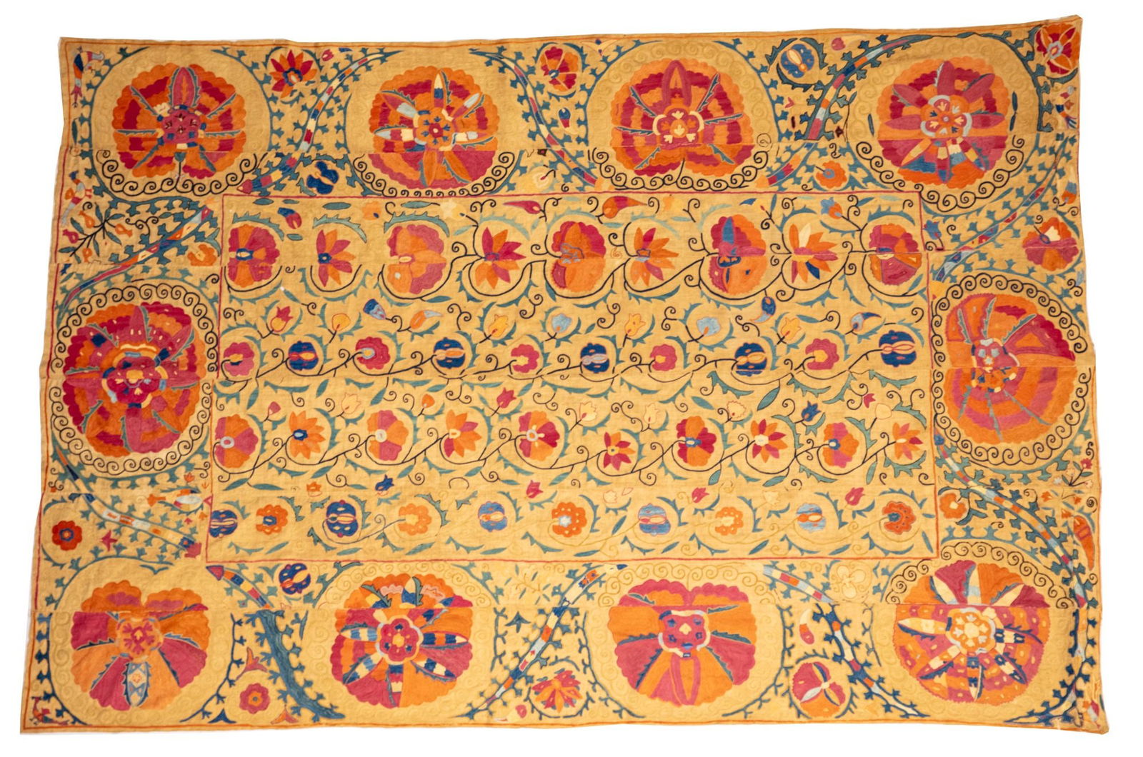 A SUZANI, BUKHARA, UZBEKISTAN,19TH CENTURY: A magnificent Bokhara suzani presenting a very dense field design. The Flower -shaped medallion in the central axis barely stand out from the wealth of flowering shrubs pointing in different direction
