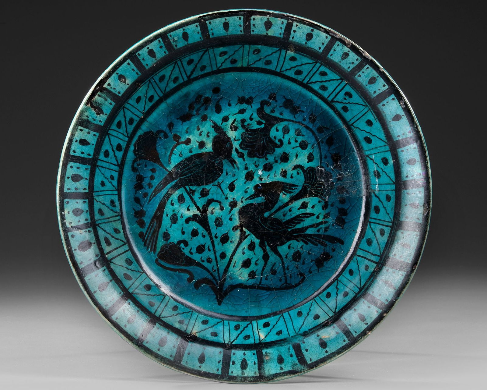 A RAQQA TURQUOISE-GLAZED POTTERY DISH, SYRIA, EARLY 13TH CENTURY (1 of 4)