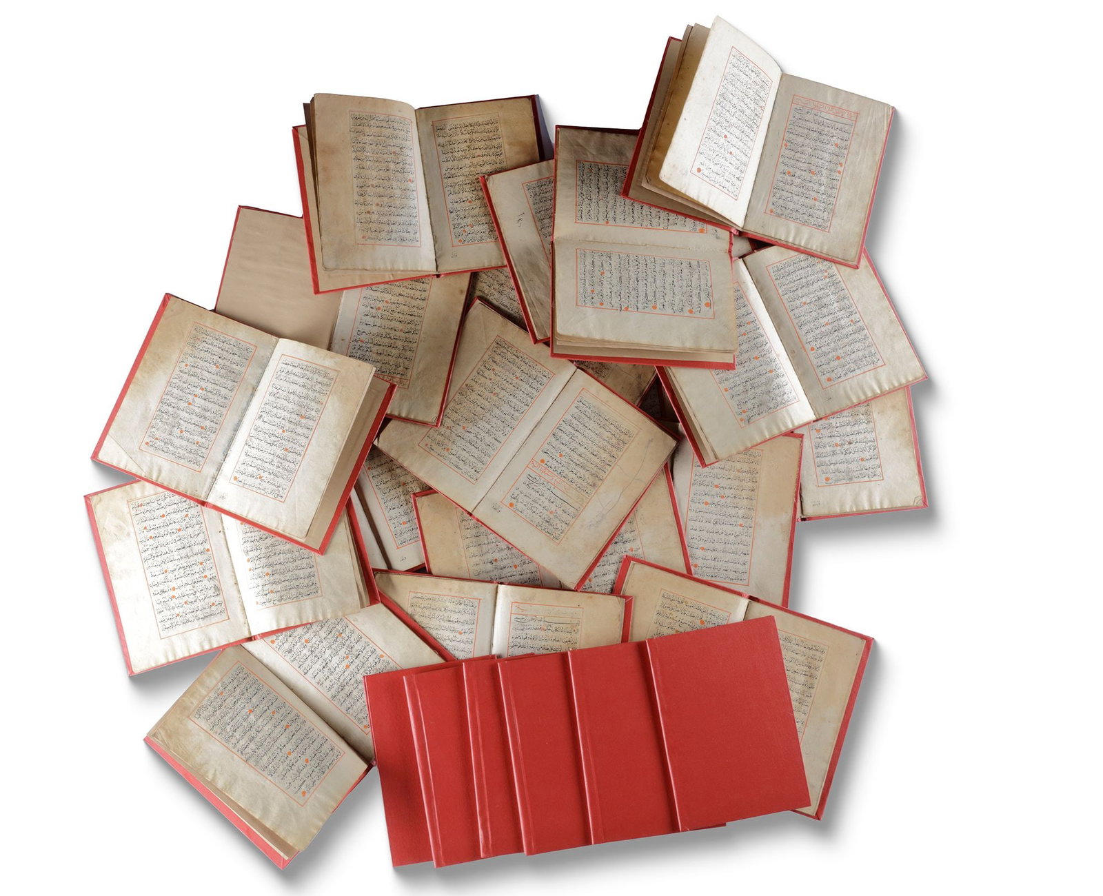 24 OTTOMAN QURAN JUZ'S (SECTIONS), 19TH-EARLY 20TH CENTURY: Arabic manuscript on paper, each Juz with 10 leaves with 15 lines to each page written in black naskh script, red roundel verse markers, ruled in red border. Dimensions: 17.5 by 12.5 cm. Condition: th