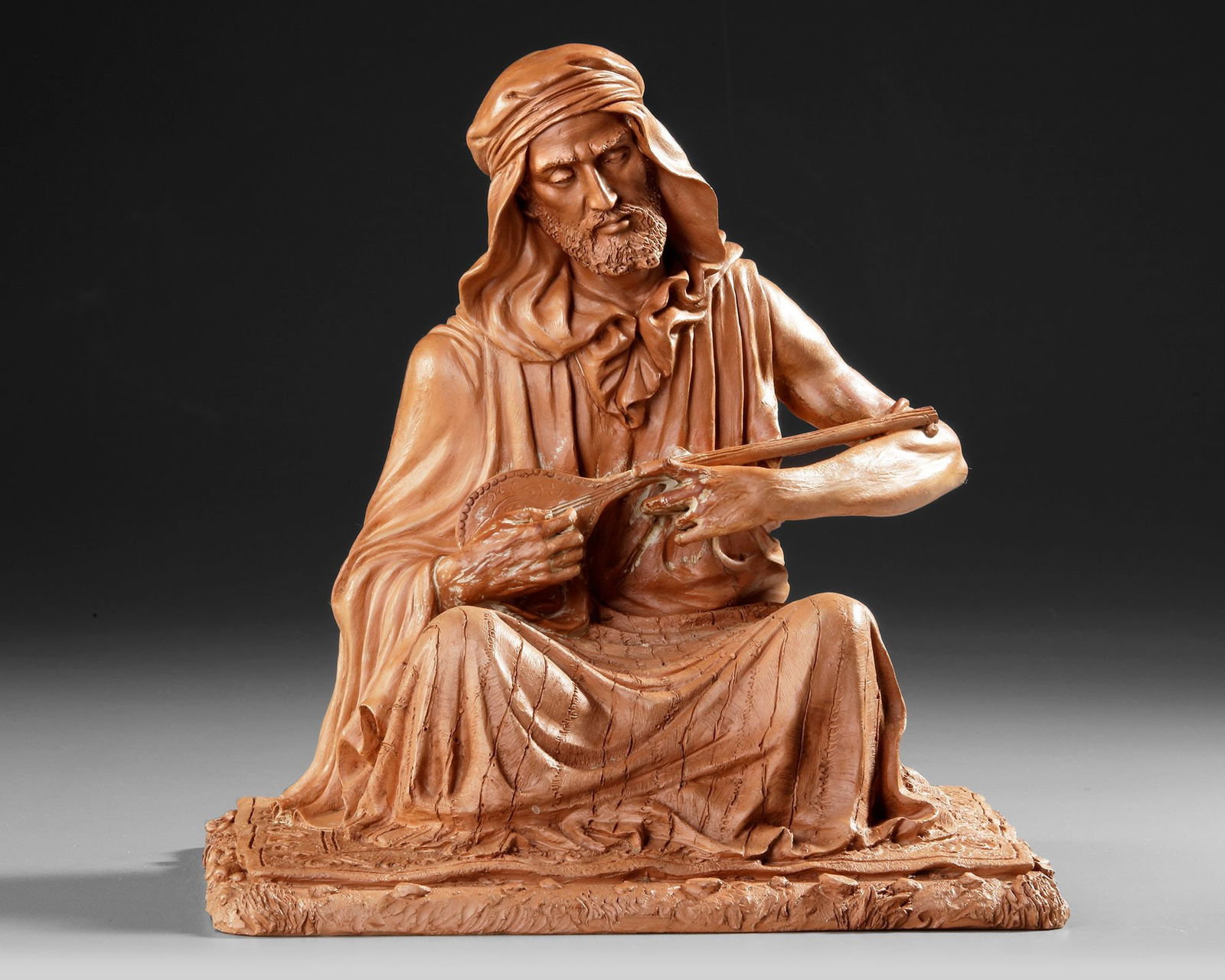 A TERRACOTTA SCULPTURE DEPICTING AN ARAB MAN (1 of 3)