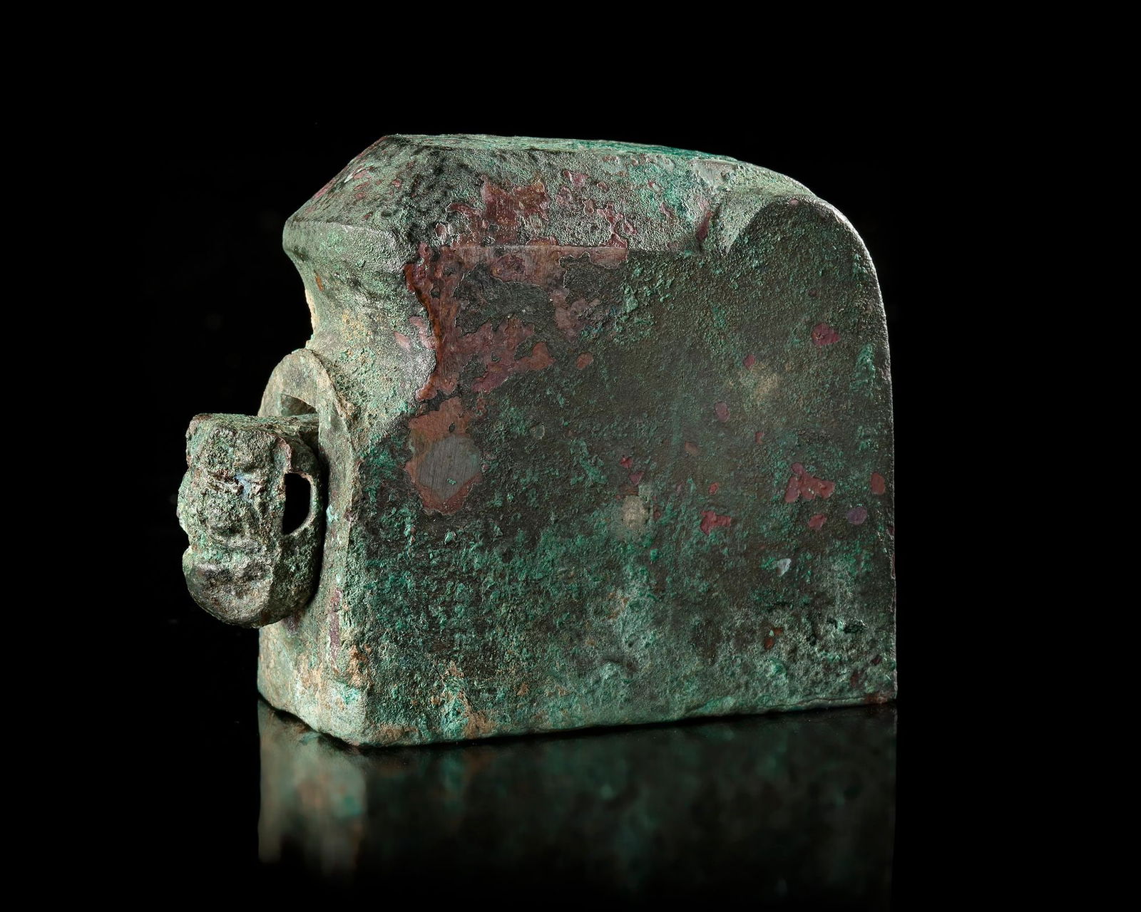 A BRONZE SEAL, CHINA, HAN DYNASTY (206 BC-220 AD): A rare ancient Chinese bronze seal , featuring a rectangular seal face with finely carved characters. The piece displays a beautiful natural green and reddish patina formed over centuries. The seal re