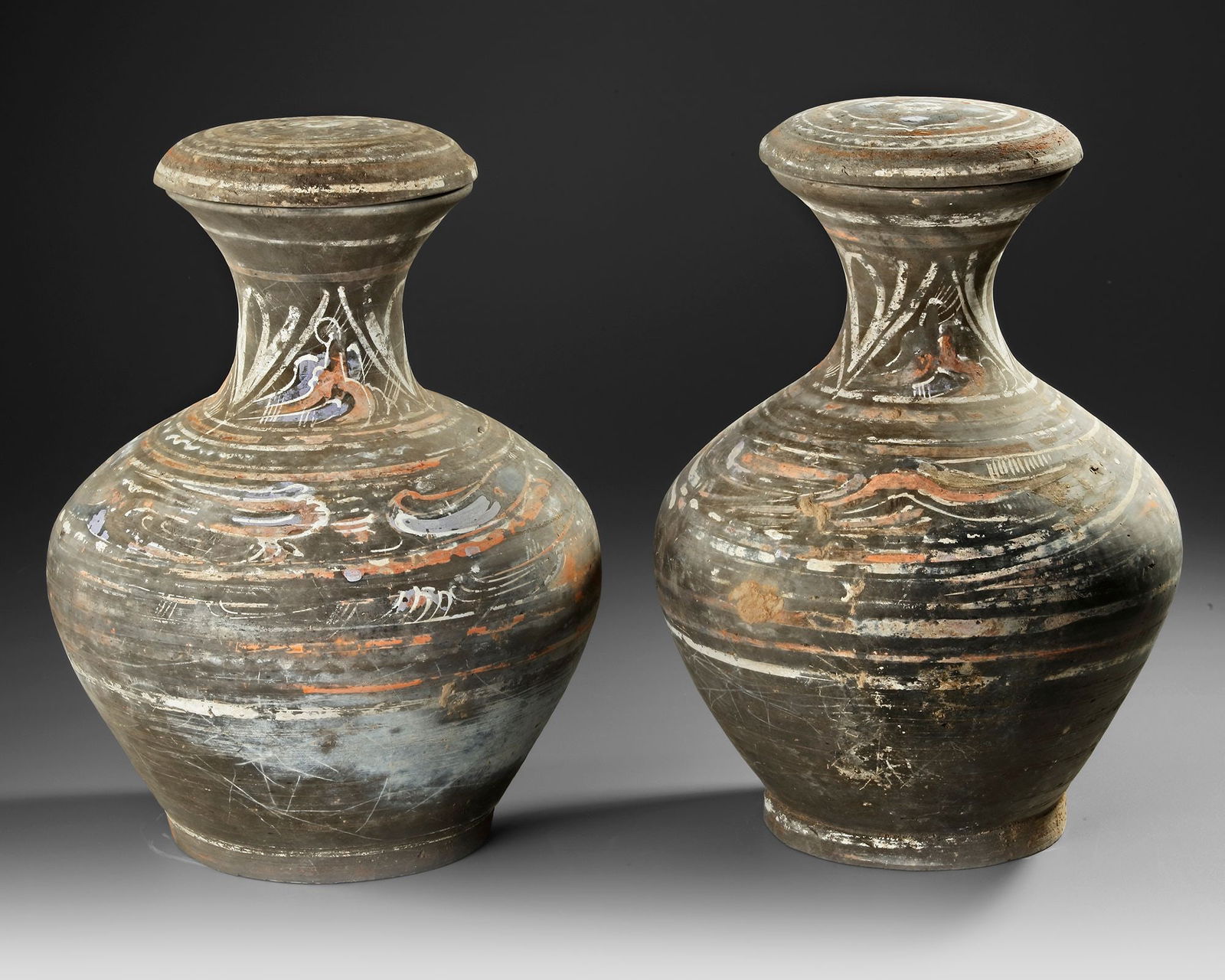 A PAIR OF PAINTED TERRACOTTA HU VASES WITH COVERS, CHINA, HAN DYNASTY (206 BC-220 AD) (1 of 2)