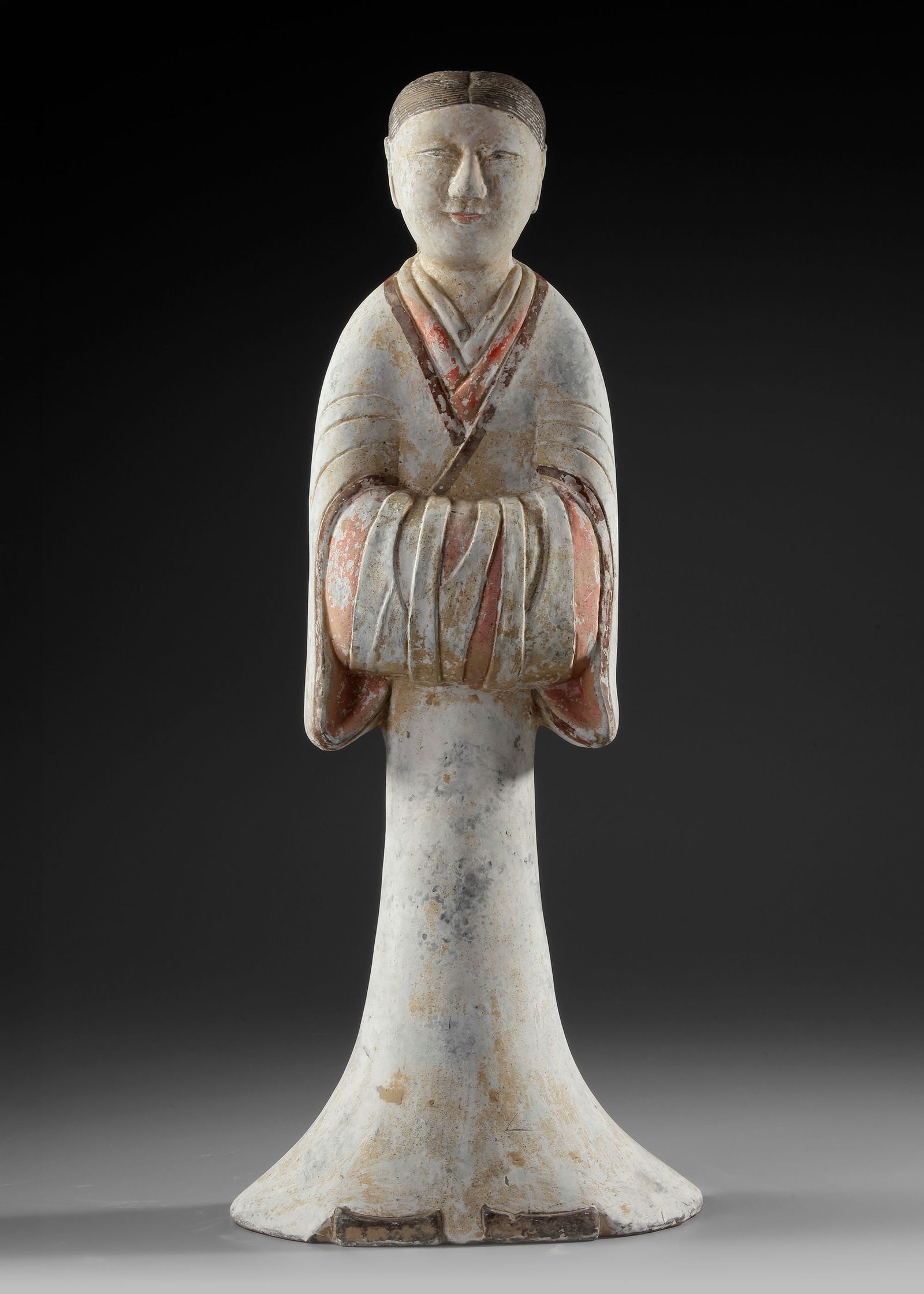 A LARGE TERRACOTTA STATUE OF A STANDING FEMALE ATTENDANT, CHINA, HAN DYNASTY (206 BC-206 AD): H. 59 cm. Wearing a long typical robe, with sleeves folded in front. Height Oxford TL tested.Provenance: Private collection, The Netherlands.
