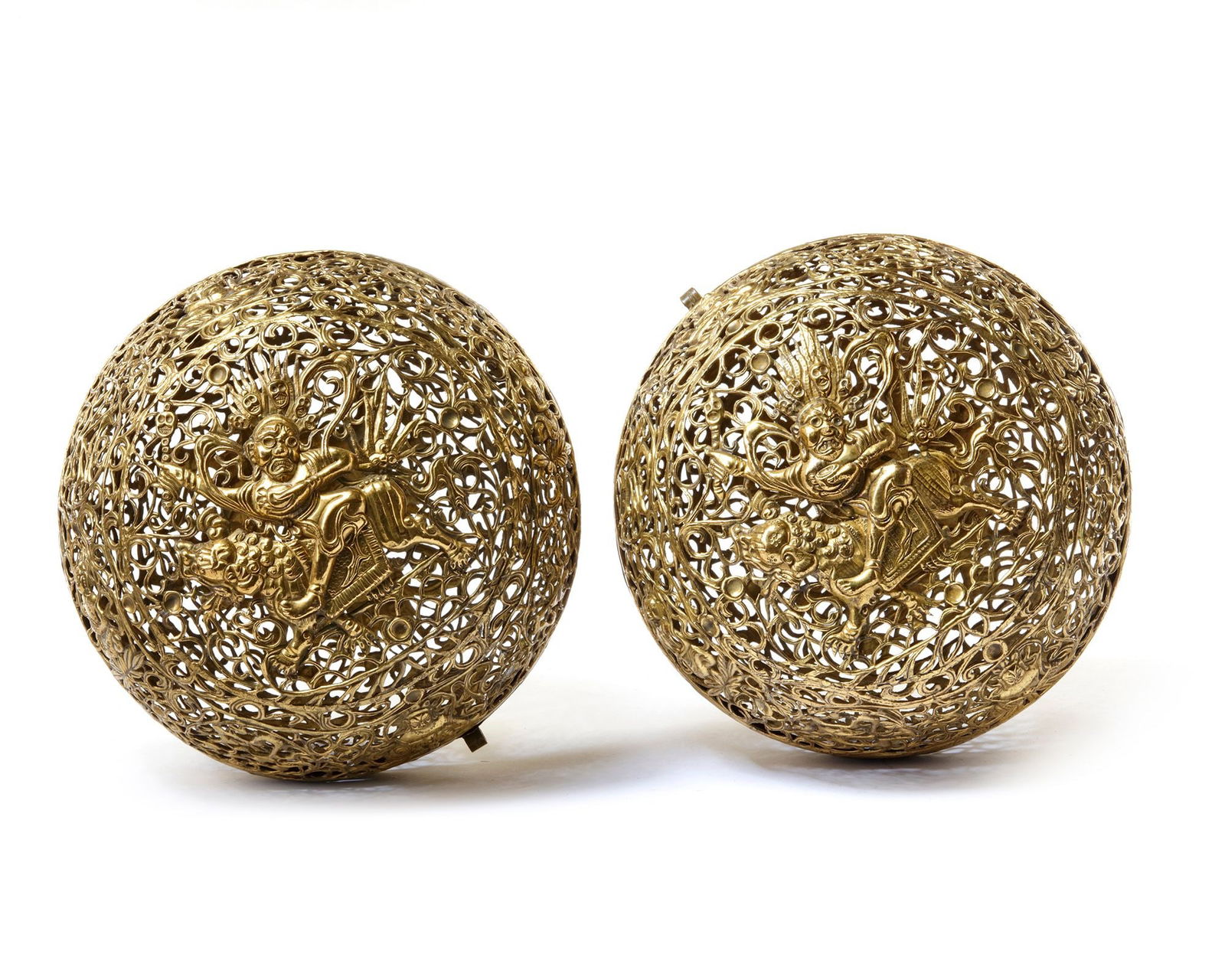 TWO HANGING TIBETAN BRASS INCENSE BURNERS, 19TH CENTURY: The burners decorated with the Tibetan auspicious symbols, Ashtamangala and figure of a seated Vajrasattva,25 cm. diam.