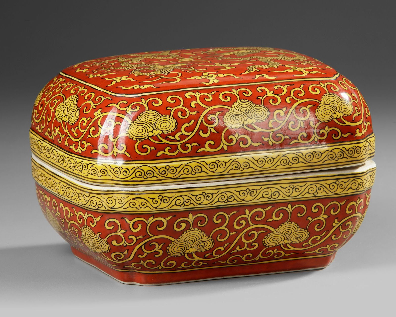 A CHINESE YELLOW-DECORATED RED-GROUND DRAGONS BOX AND COVER, QING DYNASTY (1644â€“1911) (1 of 4)