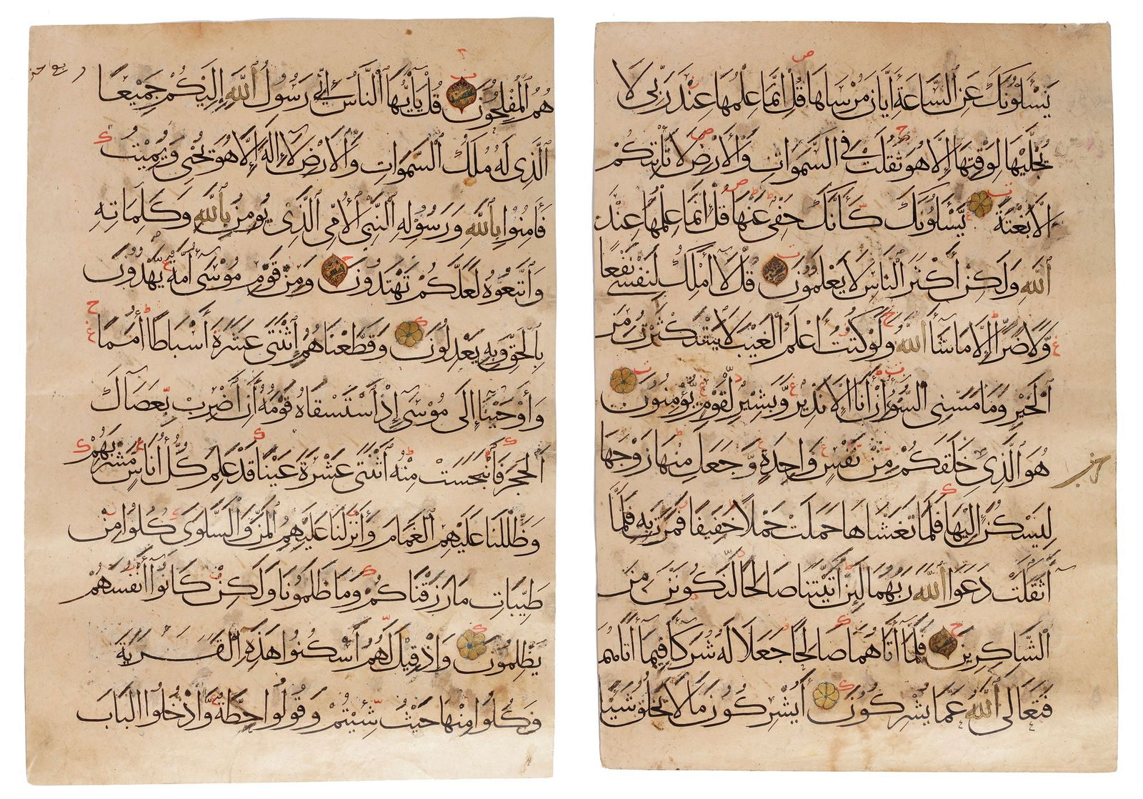 TWO LARGE MUHAQQAQ QURAN LEAVES, NEAR EAST, 14TH CENTURY: Arabic manuscript on paper, 2ff., each with 11 lines written in elegant black muhaqqaq script, gold and polychrome roundel verse markers, marginal gold 'Hizb' notes outlined in black, diactries or taj