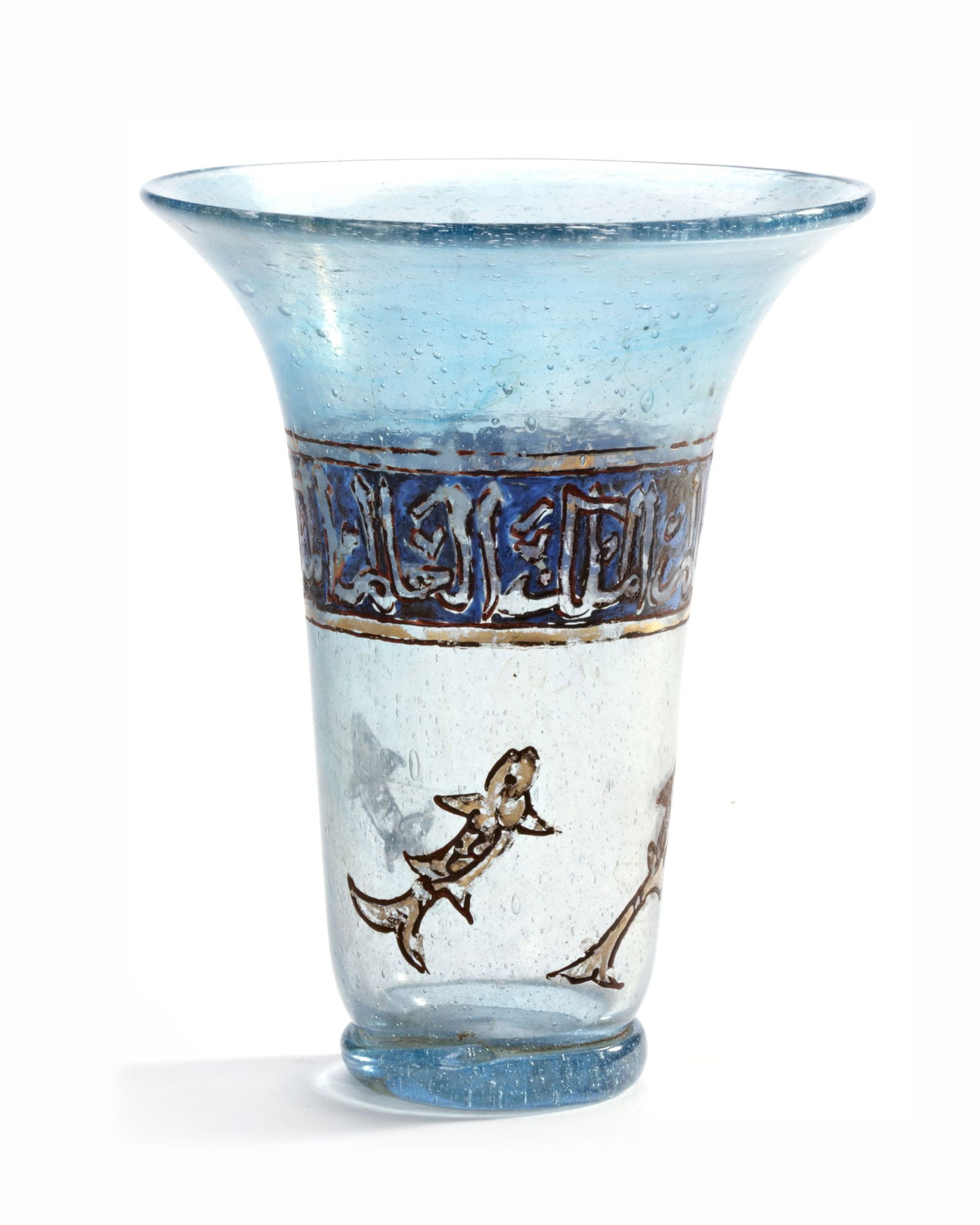 AN ISLAMIC ENAMELLED GLASS BEAKER, 19TH CENTURY: Of cylindrical form with flaring mouth, kick to base, decorated in polychrome enamel and gilt with a band of inscriptions in thuluth script on a blue ground. Height 13 cm. Inscription: three repeating