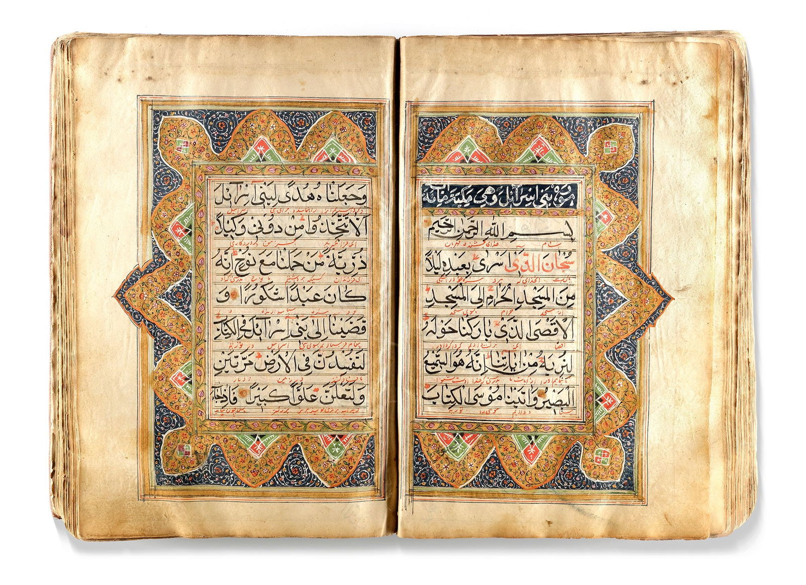 AN EARLY QAJAR ILLUMINATED QURAN, PERSIA, EARLY 19TH CENTURY: Arabic manuscript on paper, each folio with 11 lines of elegant largevblack naskh script, diacritics and vowels in red. Persian interlinear translation in red nastaliq, marginal occasional notes indic