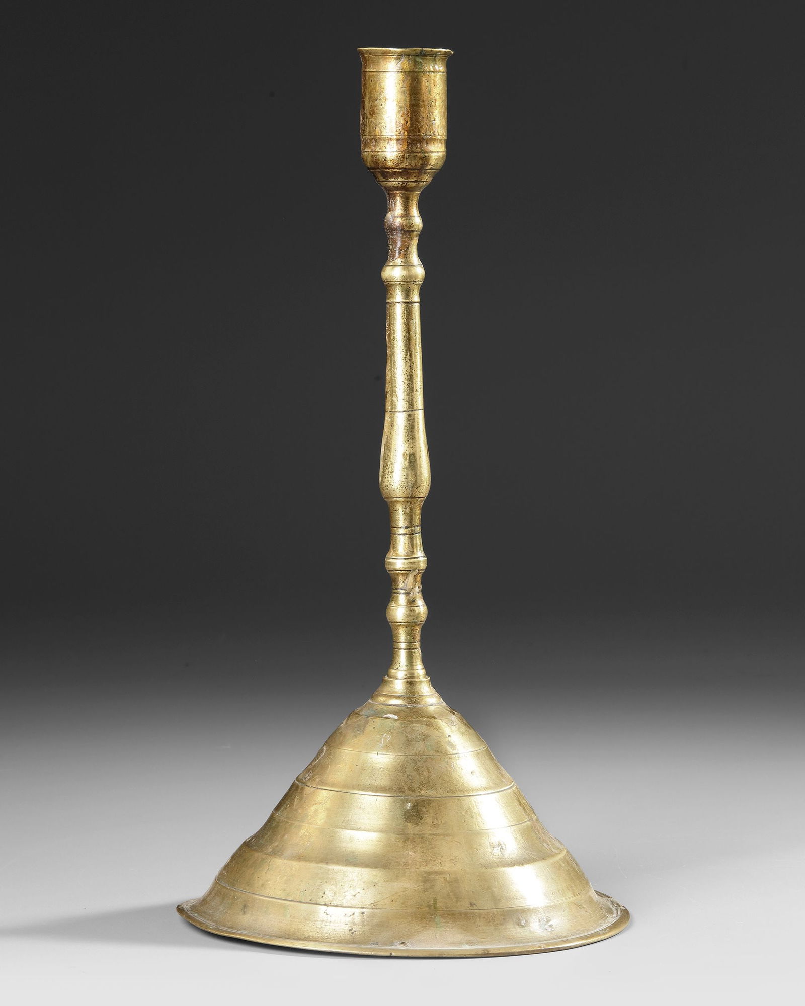 AN OTTOMAN BRASS CANDLESTICK, TURKEY, 17TH-18TH CENTURY (1 of 3)