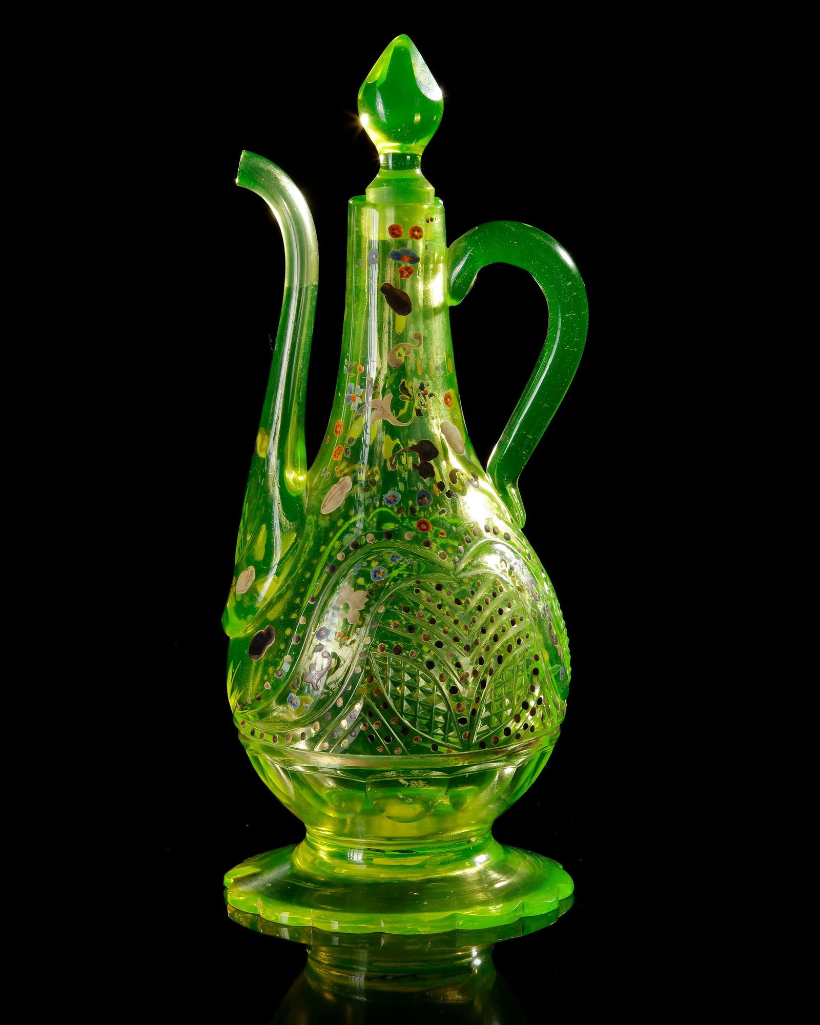 A BOHEMIAN GLASS ROSEWATER EWER, MADE FOR THE ISLAMIC MARKET, EARLY 19TH CENTURY: Of translucent uranium-green glass. The vessel stands on a broad scalloped circular foot and has a pear-shaped body rising to a tall, tapering neck, fitted with a long curved spout and an opposing loo