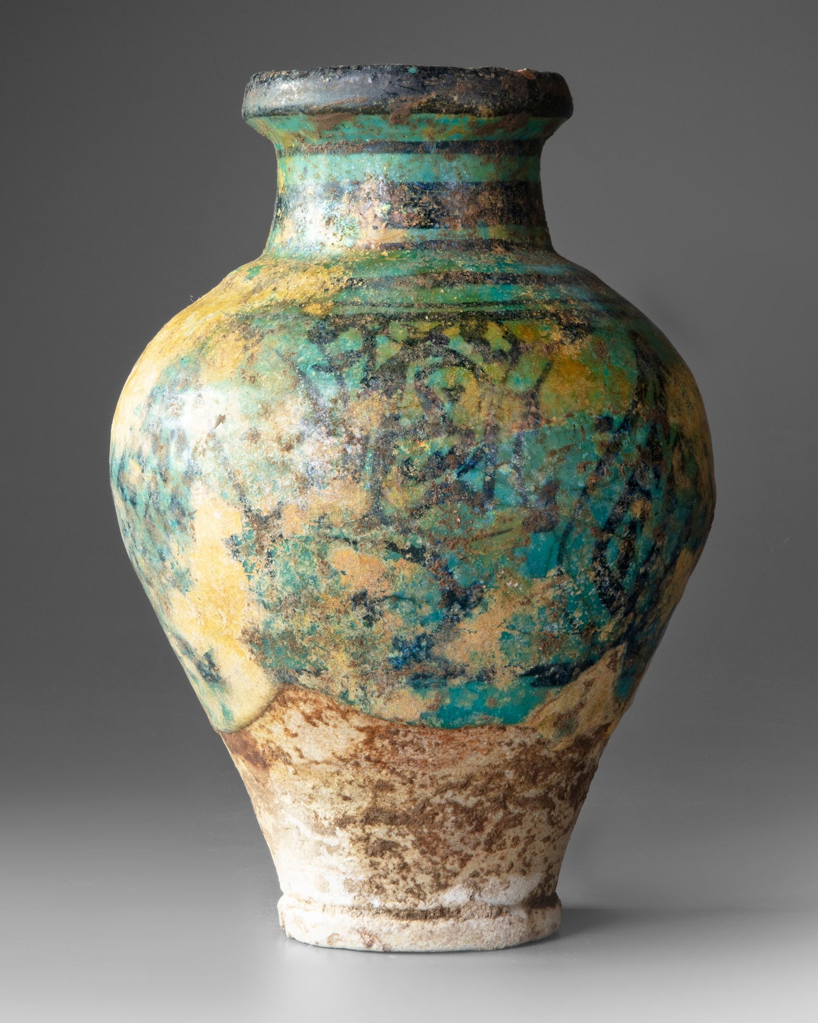 A RAQQA TURQUOISE AND BLACK GLAZED POTTERY VASE, SYRIA 12TH/13TH CENTURY (1 of 4)
