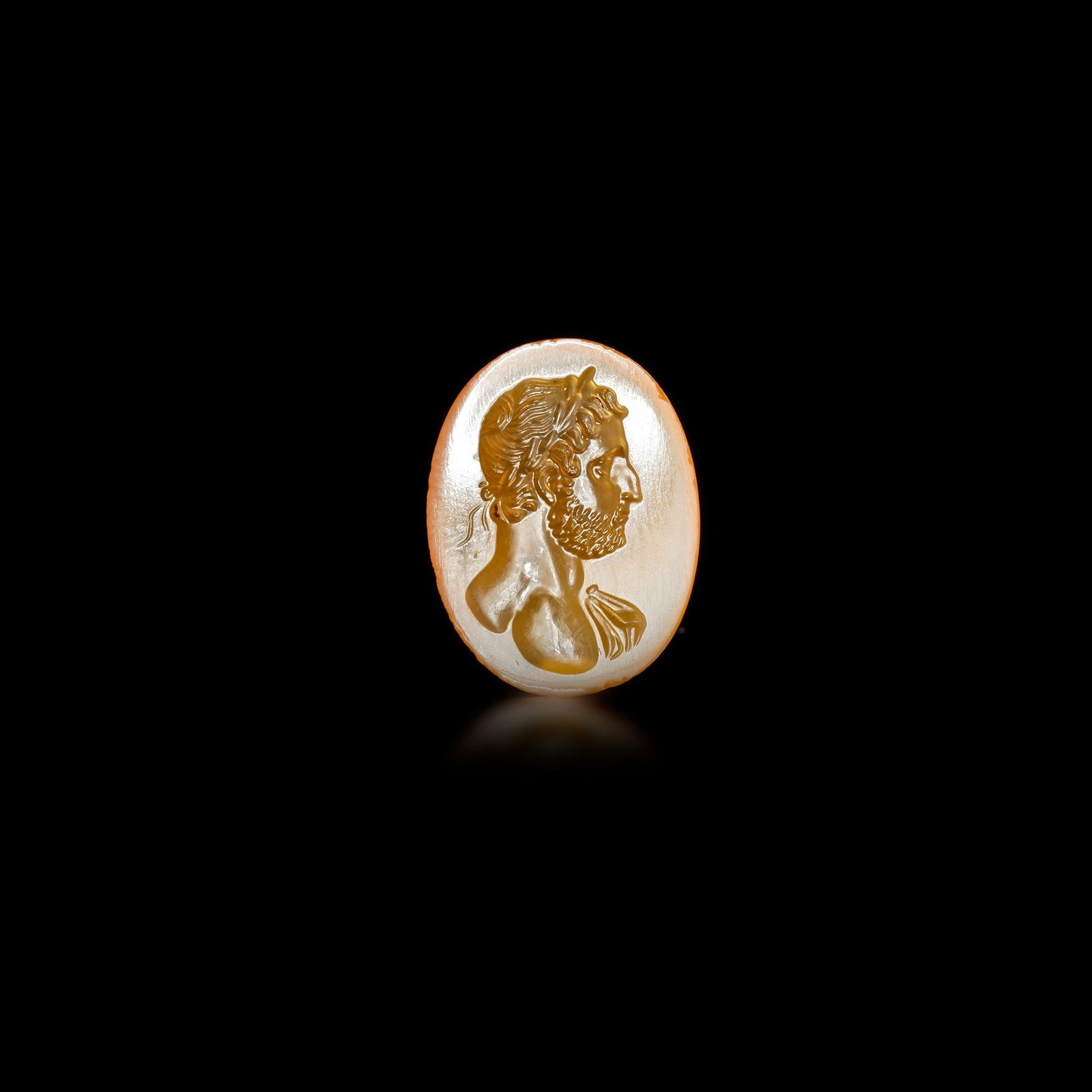 A RADIANT ORANGE AGATE ROMAN INTAGLIO OF EMPEROR HADRIAN â€“ 1ST TO 2ND CENTURY A.D. (1 of 2)