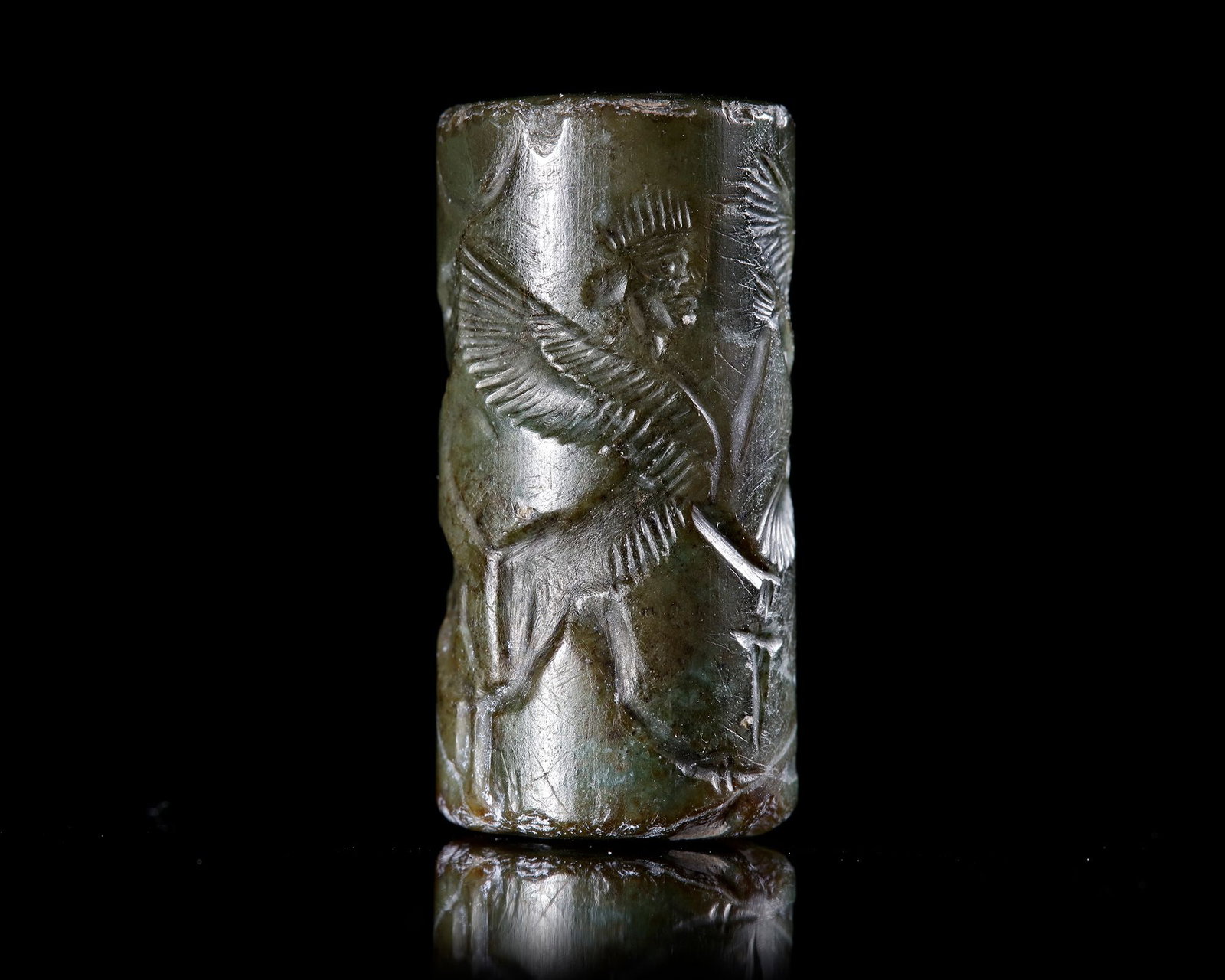 A GREEN CHALCEDONY CYLINDER SEAL, CIRCA 8TH-7TH CENTURY BC (1 of 4)