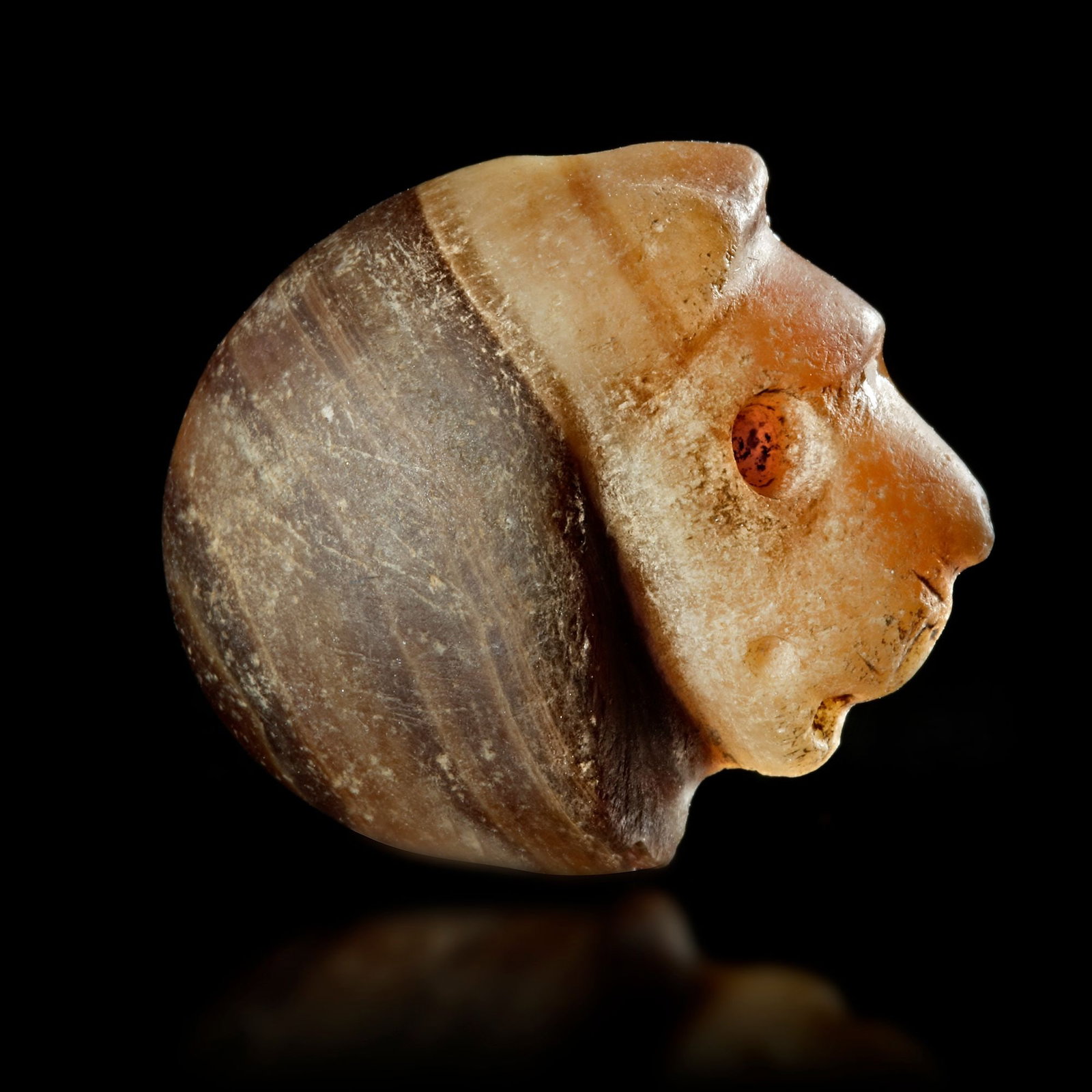 A STAMP SEAL IN THE FORM OF A LION'S HEAD IN BANDED CALCITE, 3RD MILLENNIUM BC (1 of 4)