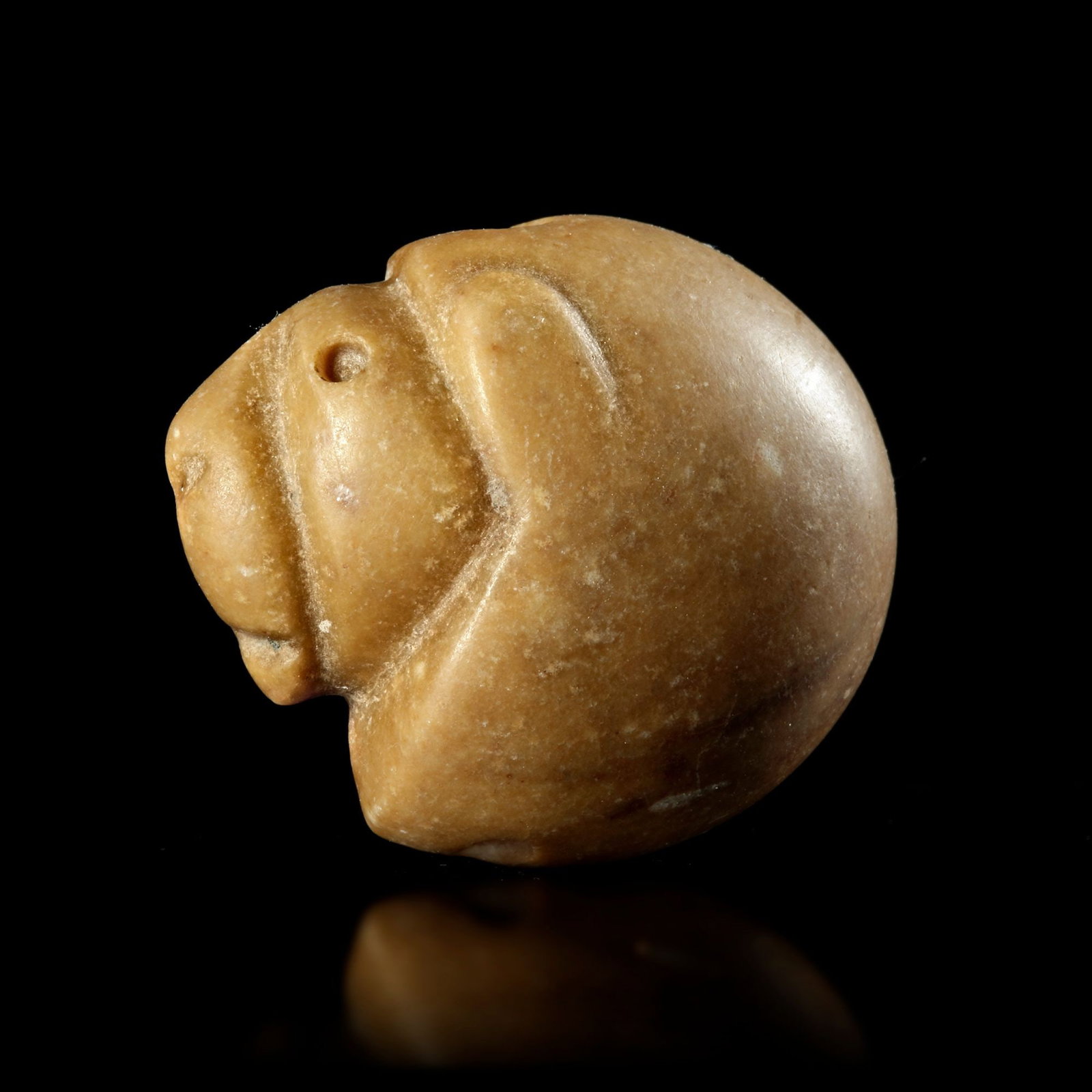 A NEAR EASTERN STAMP SEAL IN THE FORM OF A LION'S HEAD IN YELLOW CALCITE. 3rd. mil.B.C. (1 of 4)
