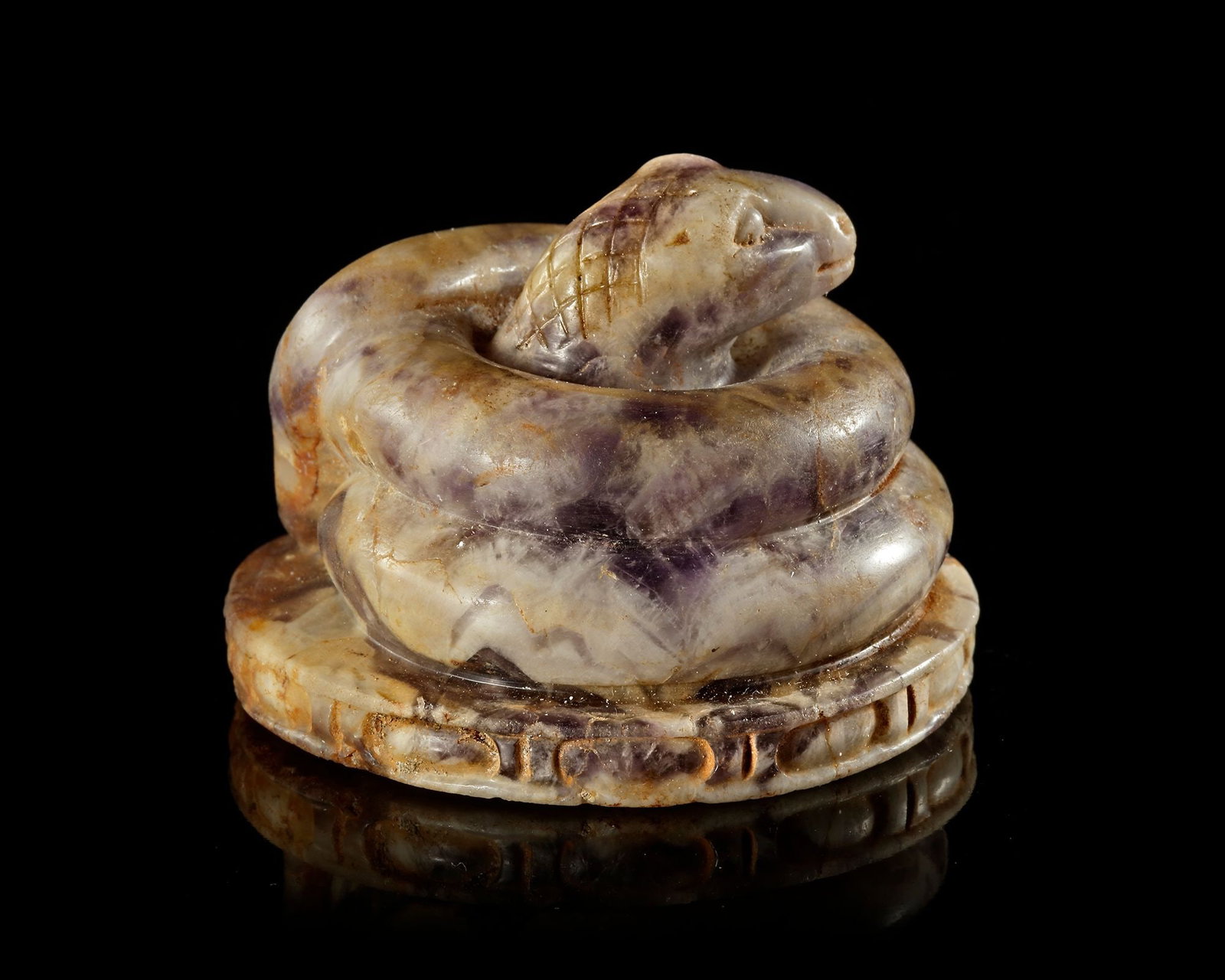 A ROMAN AMETHYST FIGURE OF A COILED SNAKE, 2ND-3RD CENTURY AD (1 of 3)