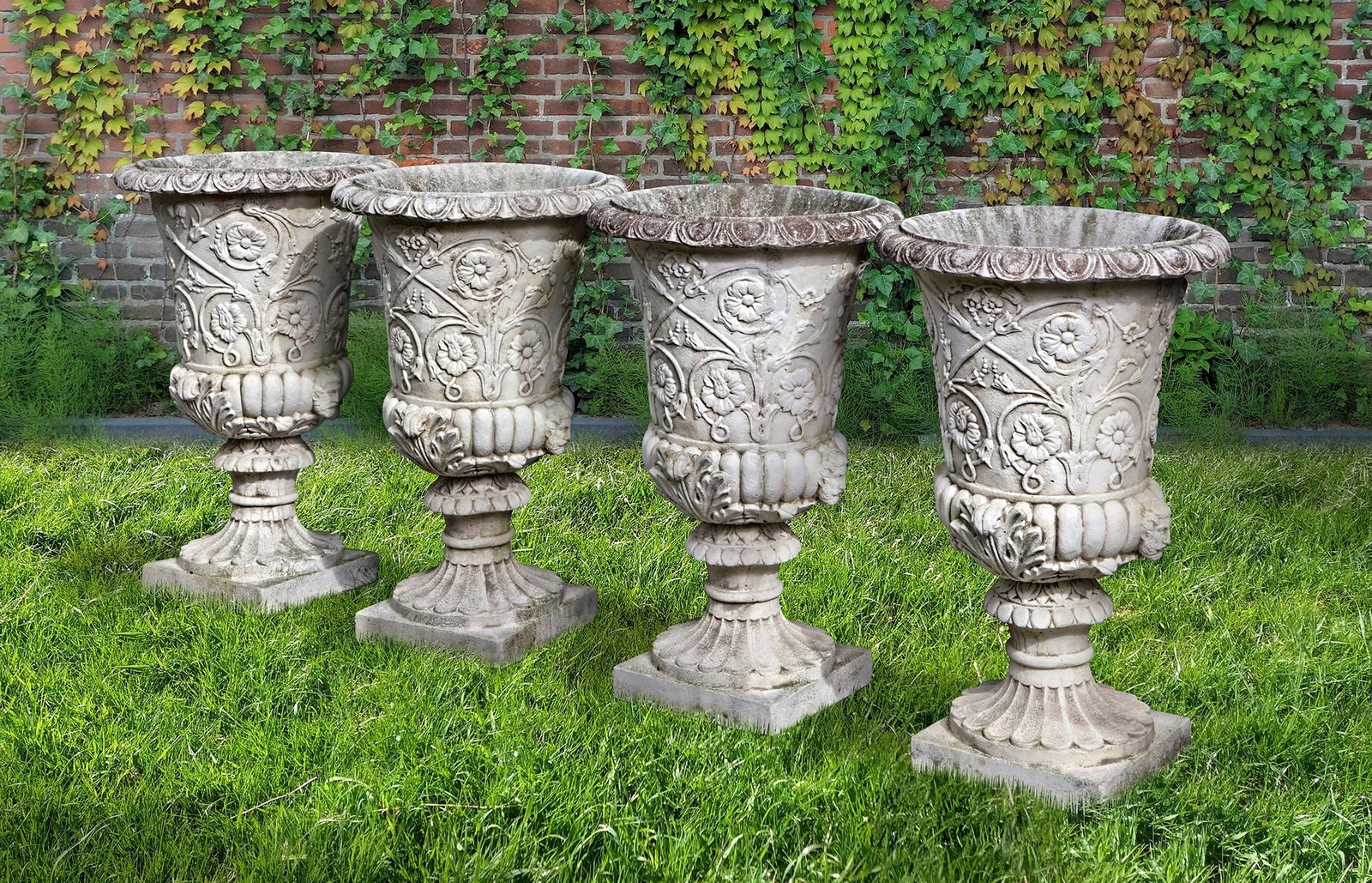 A SET OF FOUR WHITE COMPOSITION STONE GARDEN URNS IN THE ROMANTIC CLASSICAL MANNER, SECOND HALF 20TH: Each height 95 cm. Square at the base 37 cm.
