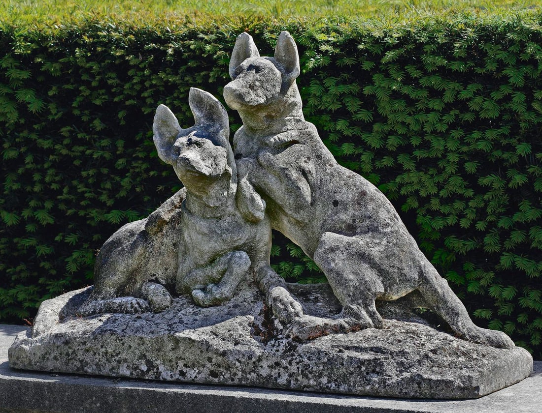 A SCULPTED LIMESTONE GROUP OF TWO DOGS, EARLY 20TH CENTURY, INSCRIBED TH. CARTIER (FRENCH 1879-1943): On a rectangular base. Height 48 cm. Width 72 cm. Depth 28 cm. Carter was a native of Marseilles, later studying under Georges Cadet and specializing in animal sculpture. He exhibited at the Salon fro