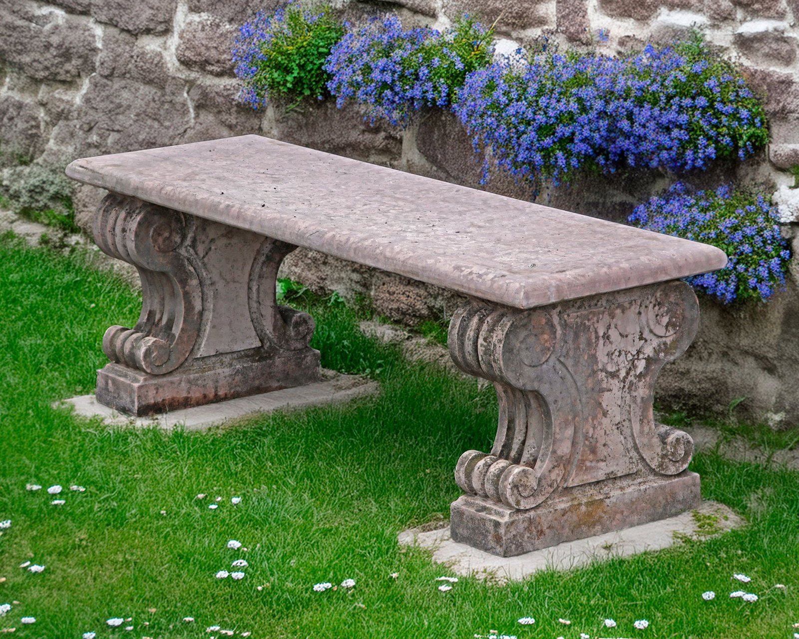 A CARVED ROSSO VERONA GARDEN SEAT: The rectangular top rests on 2 fluted supports. Length 125 cm. Height 44 cm.