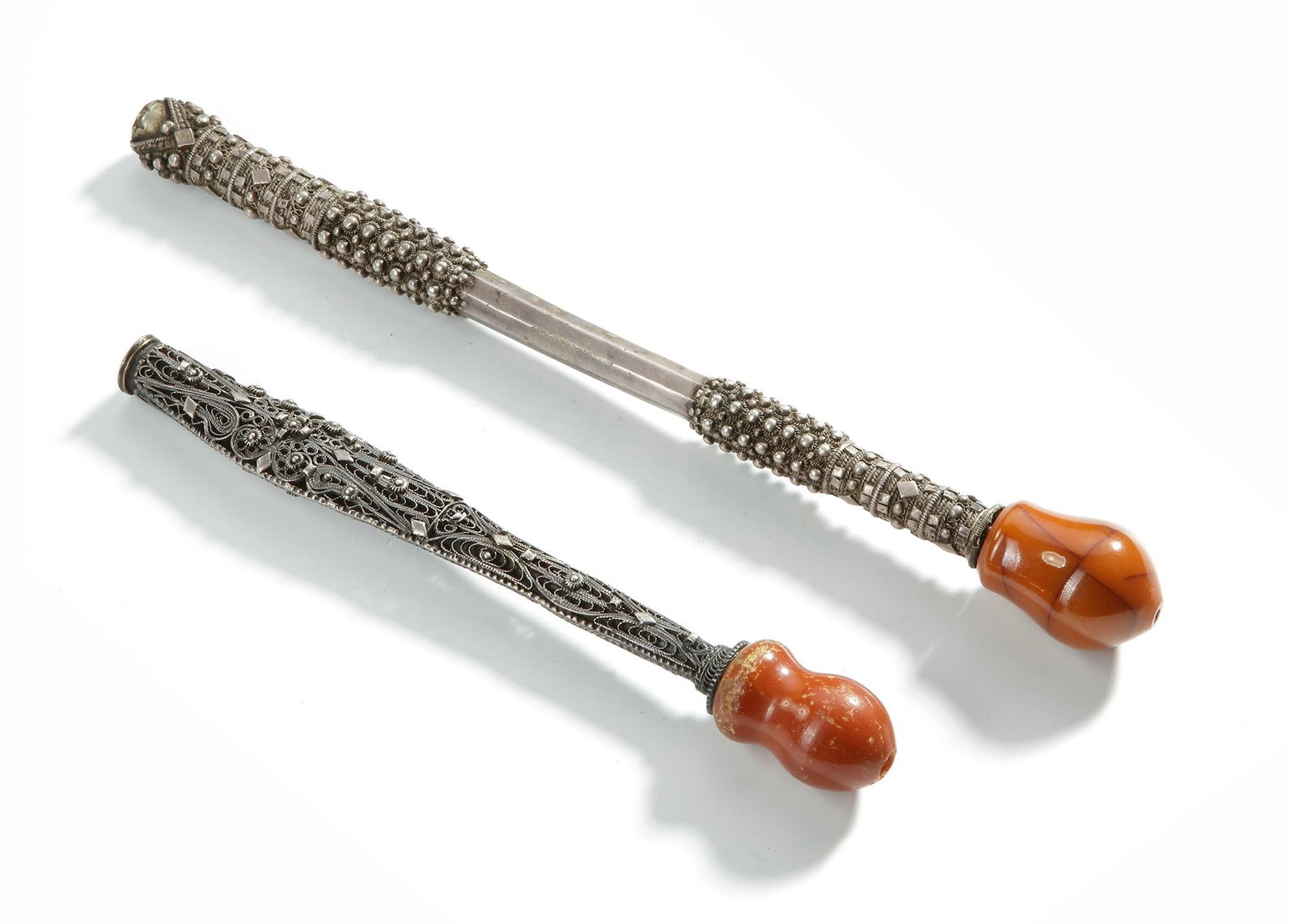 A PAIR OF OTTOMAN AMBER AND SILVER PIPES MOUTHPIECES, 19TH CENTURY: 1- 24 cm. 2- 18 cm. 162 gr.