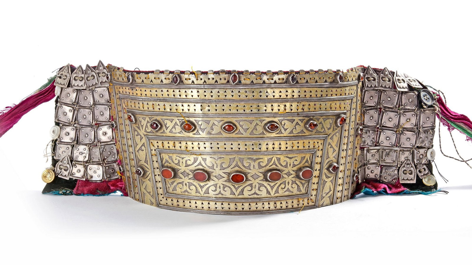 A SILVER HEADDRESS, TURKMENISTAN, 19TH CENTURY: Richly decorated with engraved patterns, carnelian stones, and textile backing. 25 by 14 360 gr. THE DR. SAAD AL-JADIR COLLECTION